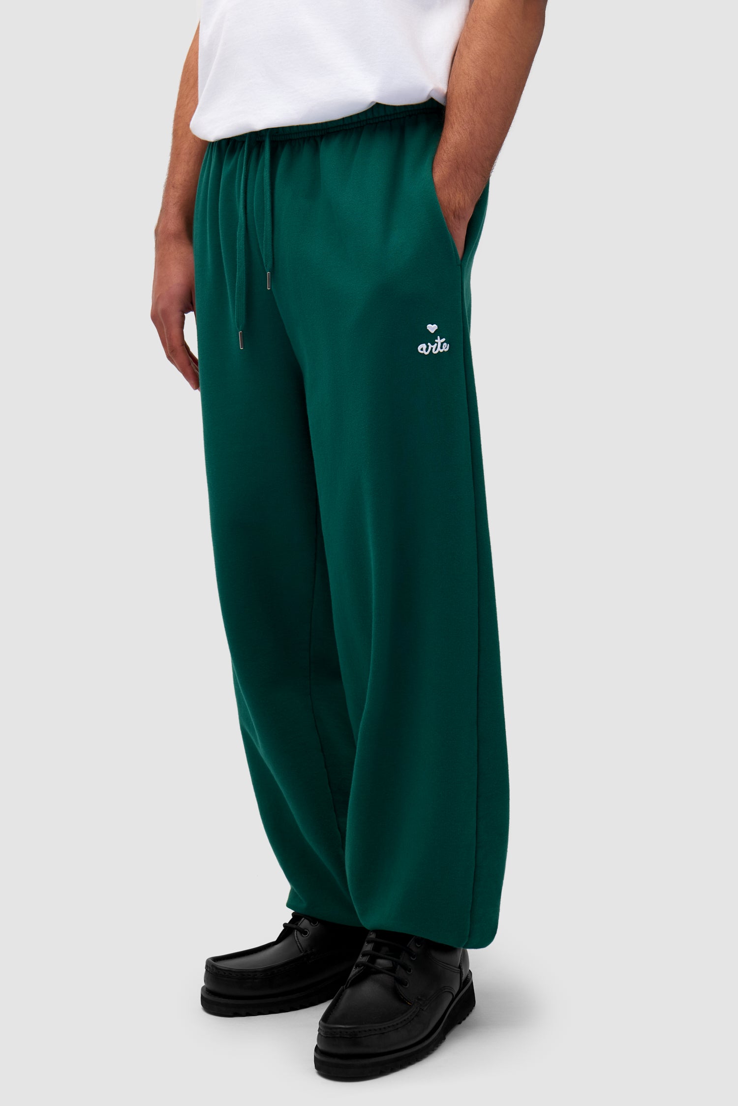 Heart Logo Sweatpants in Green worn by a model, half-body front view