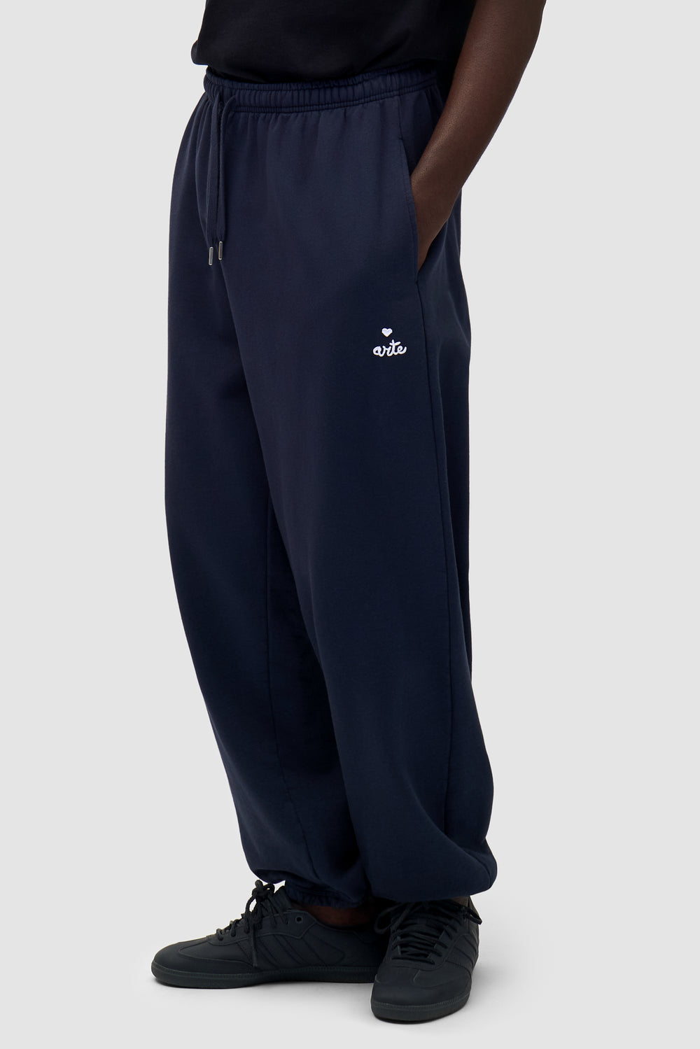 Heart Logo Sweatpants in Navy worn by a model, half-body front view