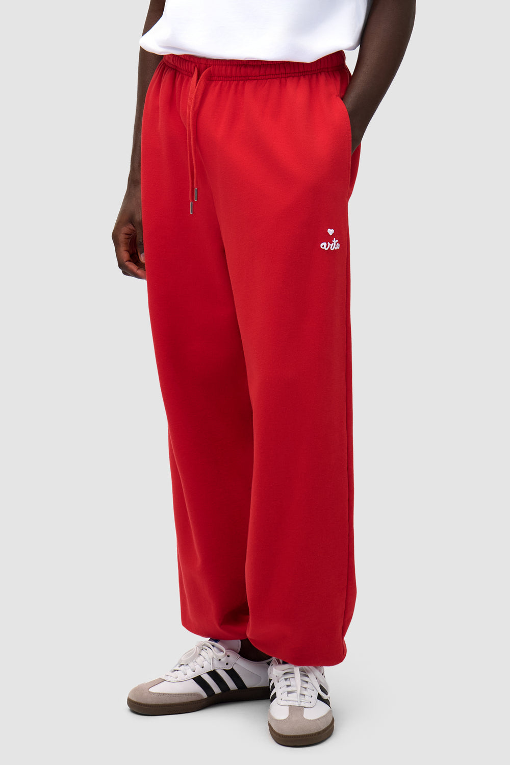Heart Logo Sweatpants in Red worn by a model, half-body front view