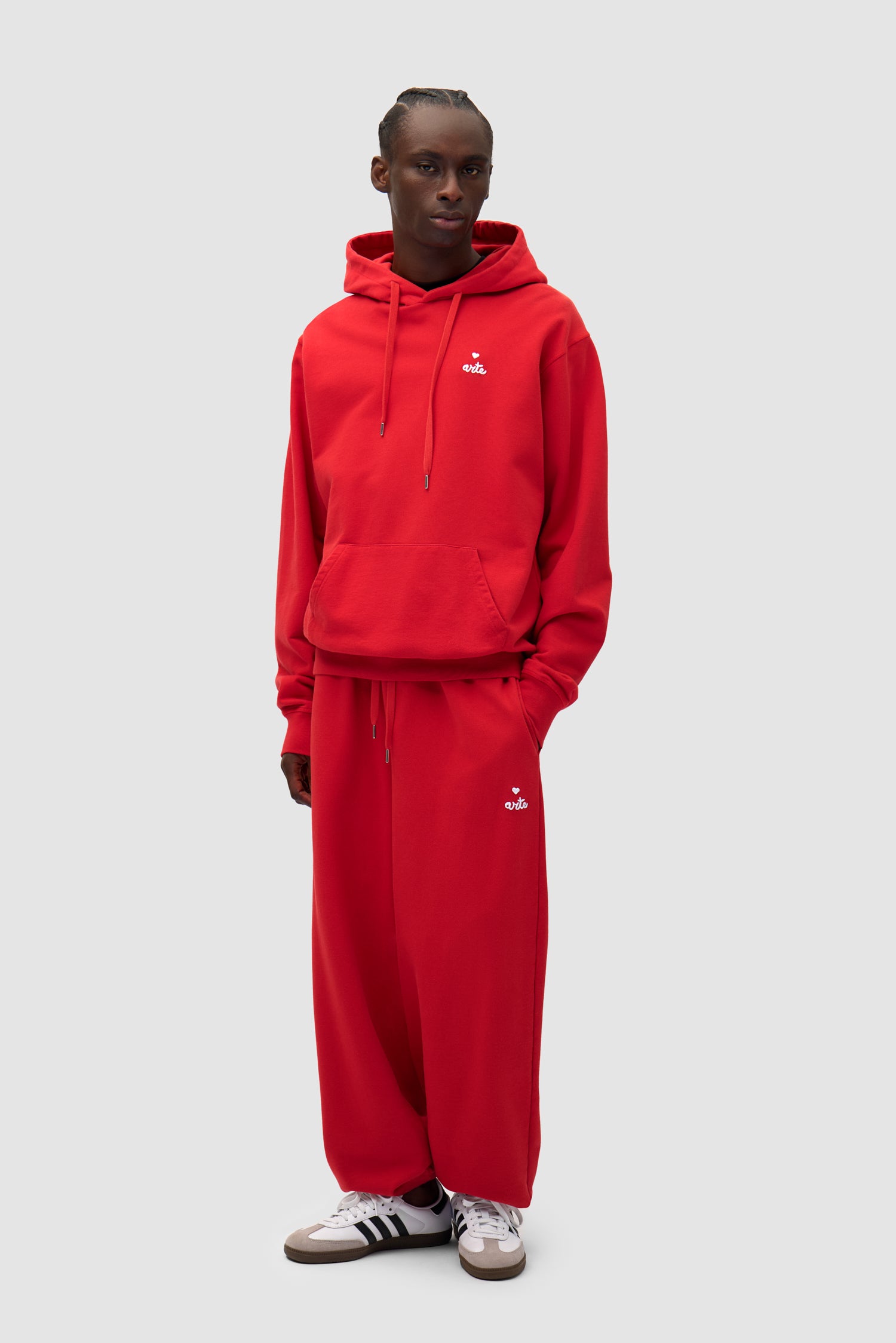 Heart Logo Sweatpants in Red worn by a model, full-body front view
