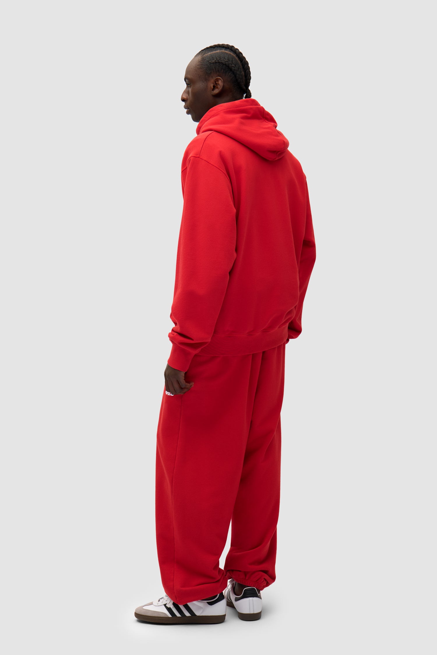 Heart Logo Sweatpants in Red worn by a model, full-body back view