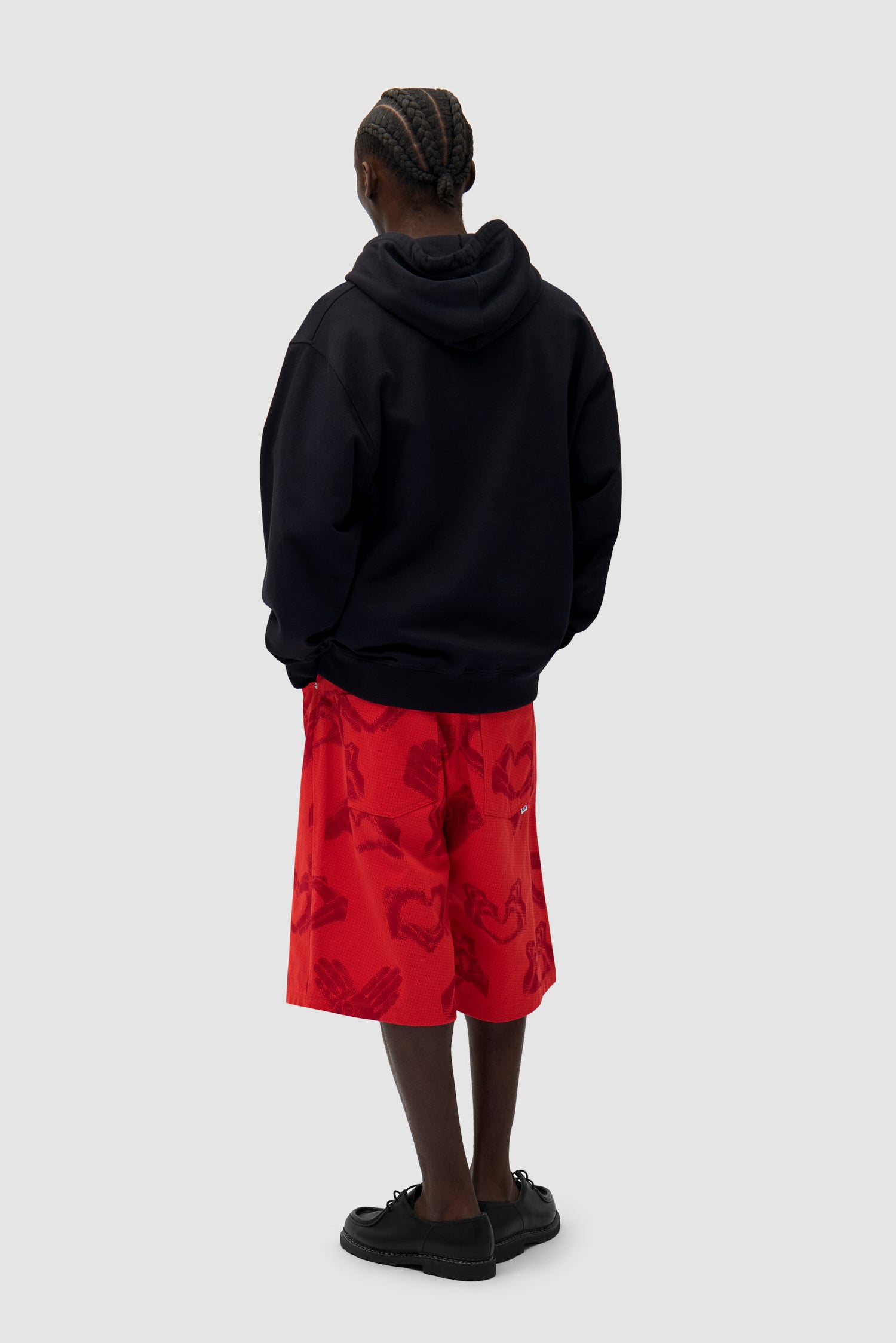 Heart Zip Hoodie in Black worn by a model, full-body back view