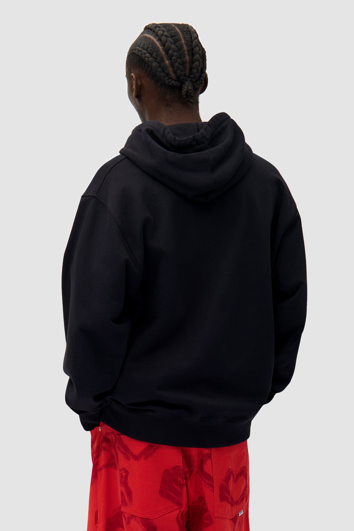 Heart Zip Hoodie in Black worn by a model, half-body back view