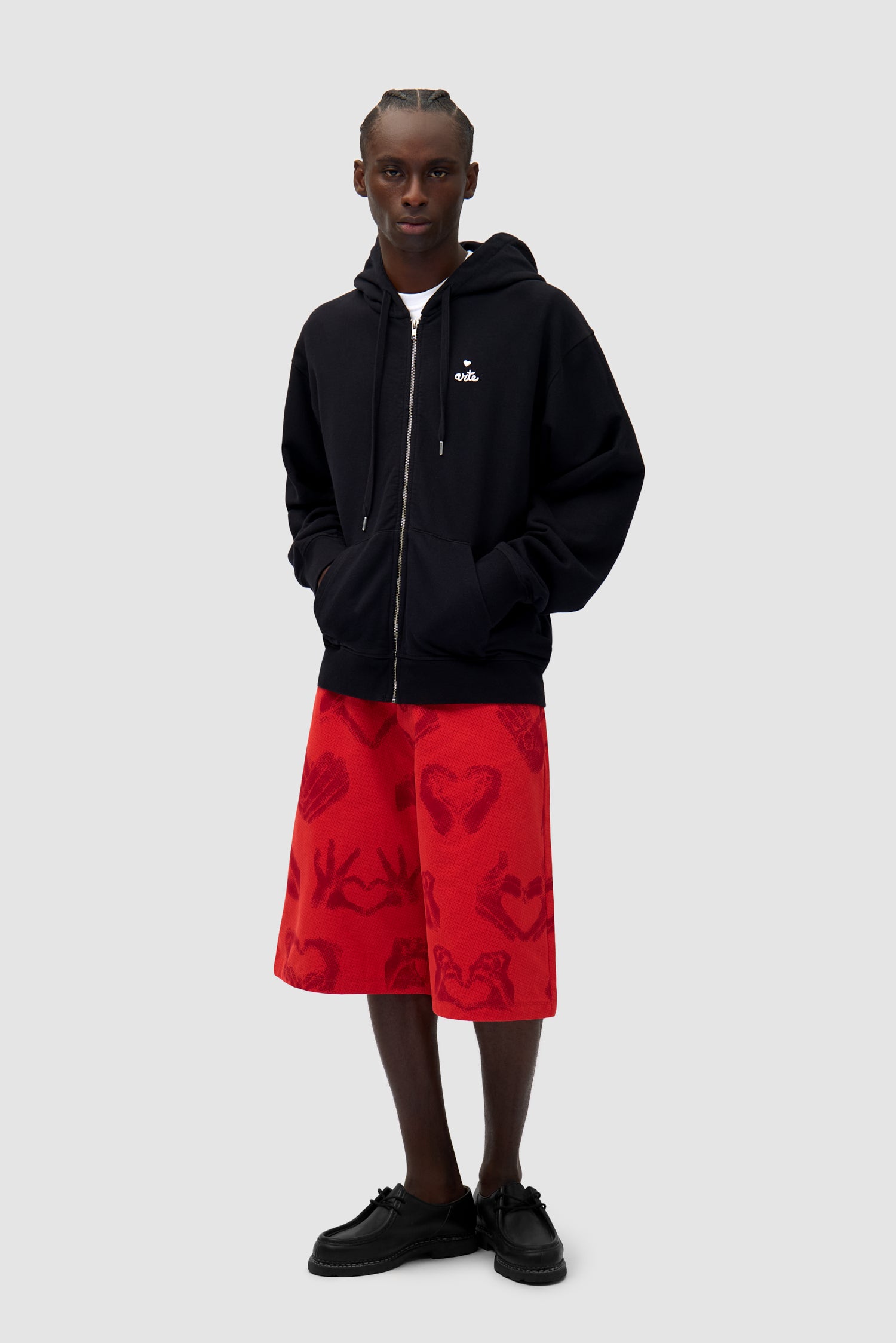 Heart Zip Hoodie in Black worn by a model, full-body side view