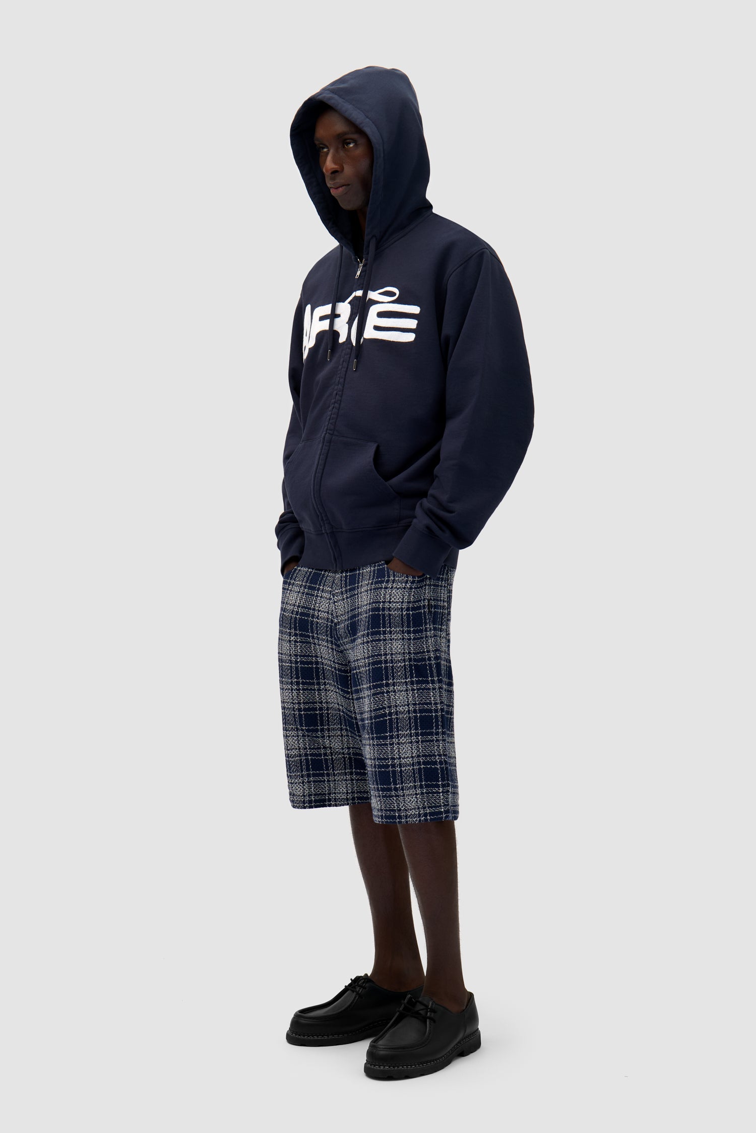 Energy Zip Hoodie in Navy worn by a model, full-body side view