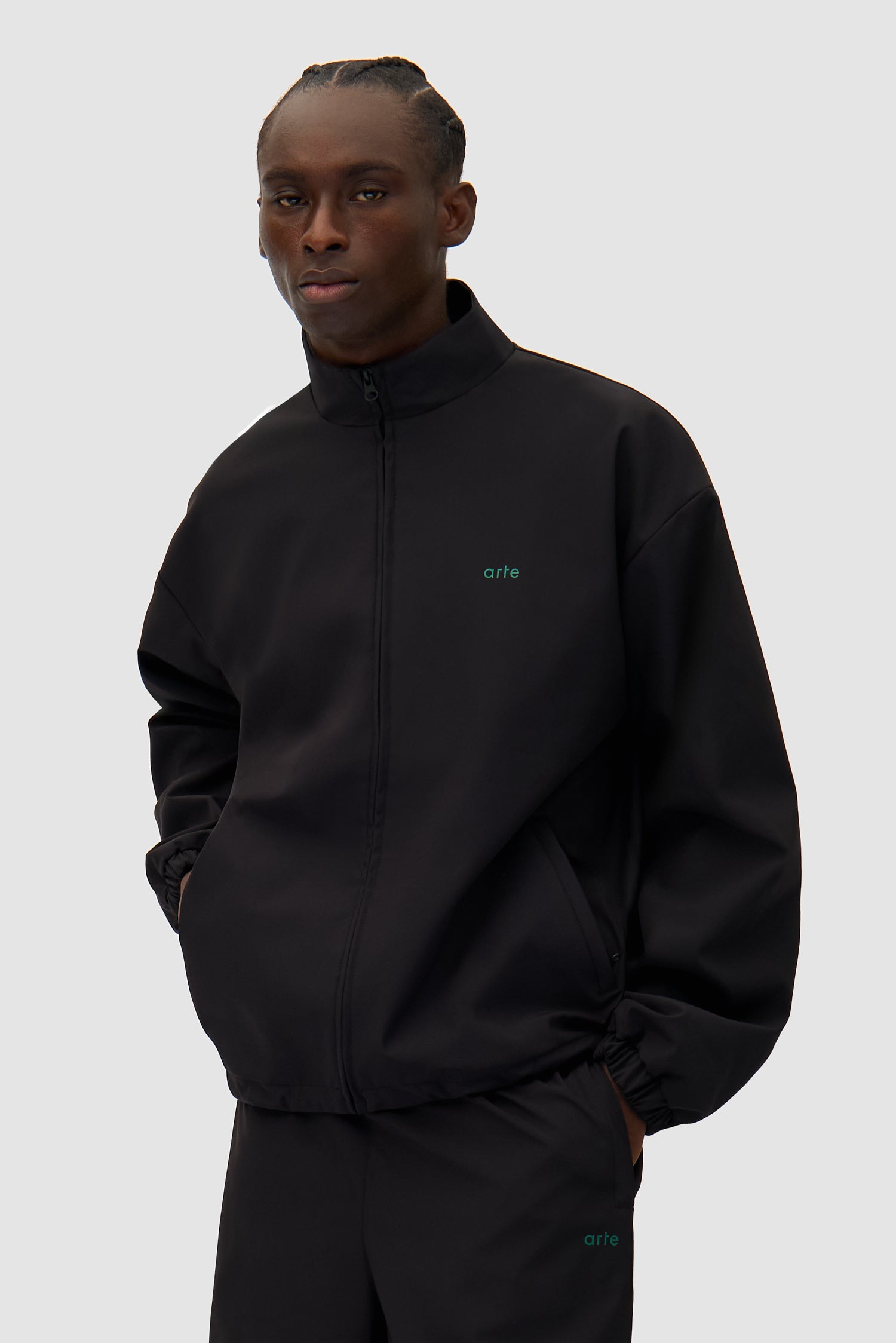 Green Logo Jacket in Black worn by a model, half-body back view