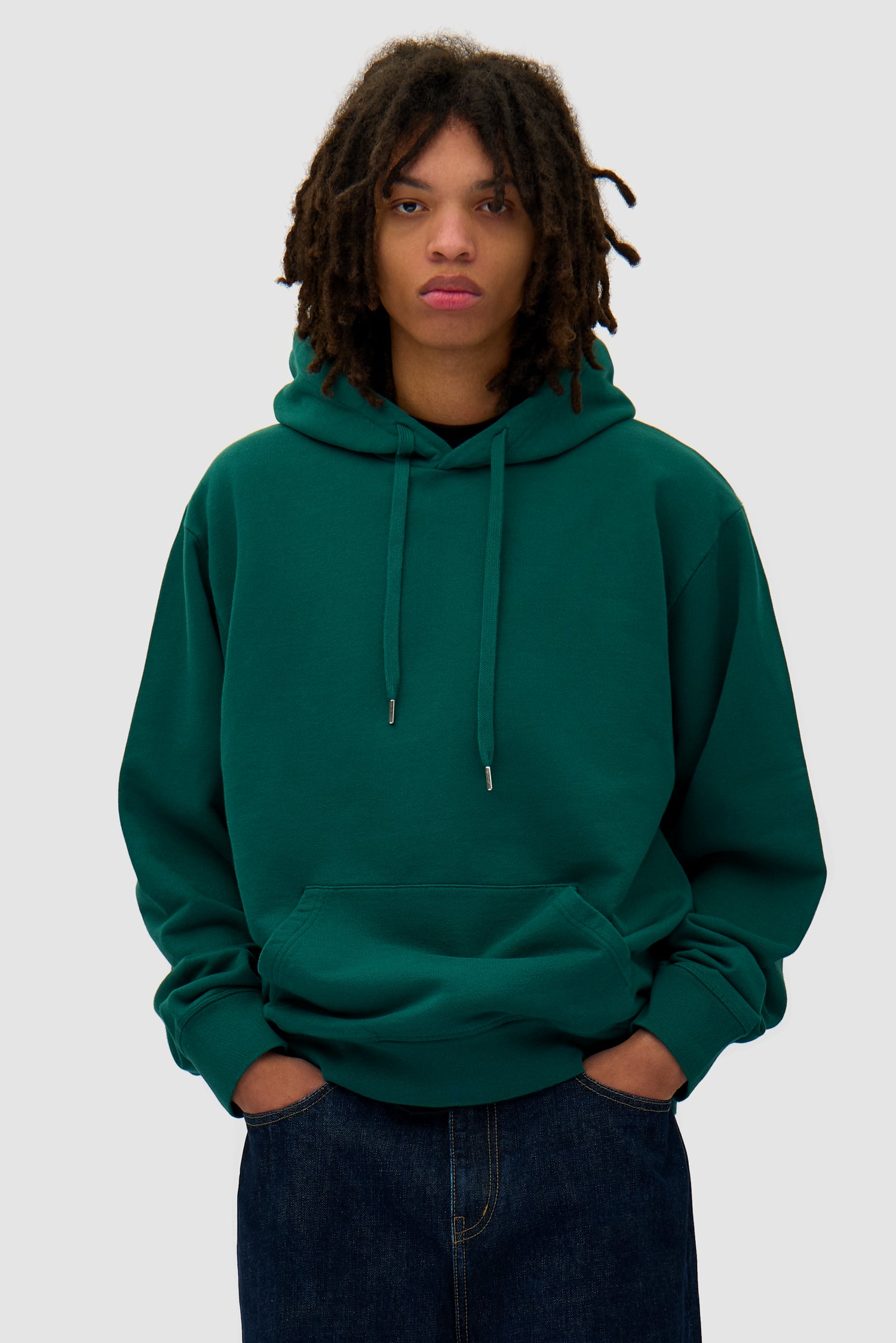 Energy Hoodie in Green worn by a model, half-body back view