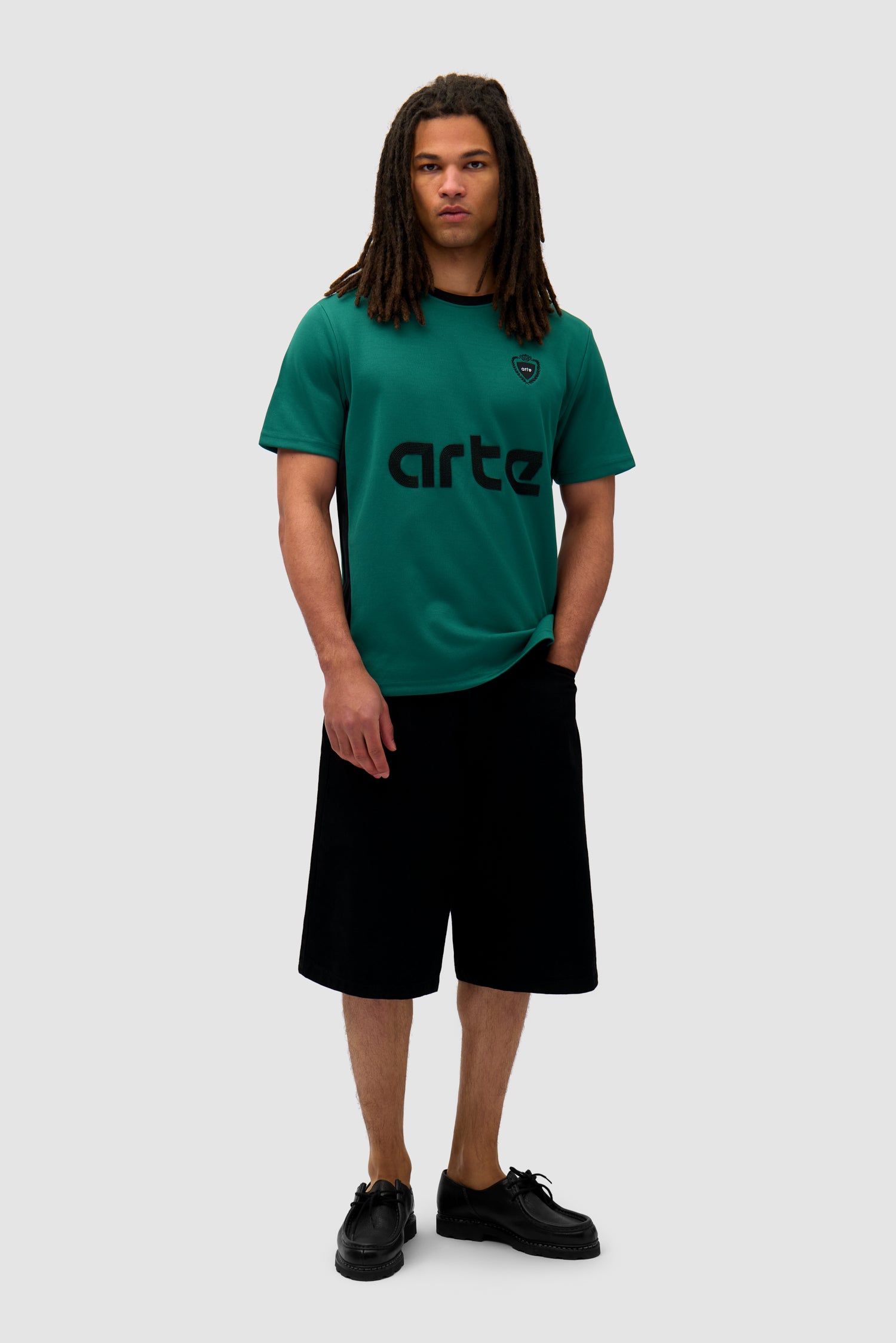 Footbal T-shirt in Green/Black worn by a model, full-body front view