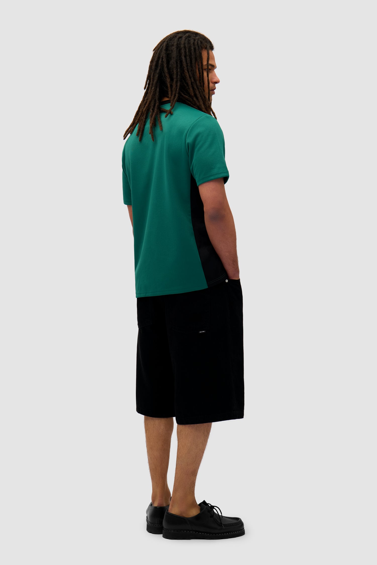 Footbal T-shirt in Green/Black worn by a model, full-body back view