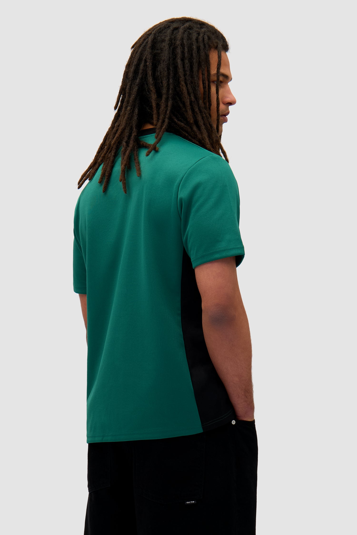 Footbal T-shirt in Green/Black worn by a model, half-body back view
