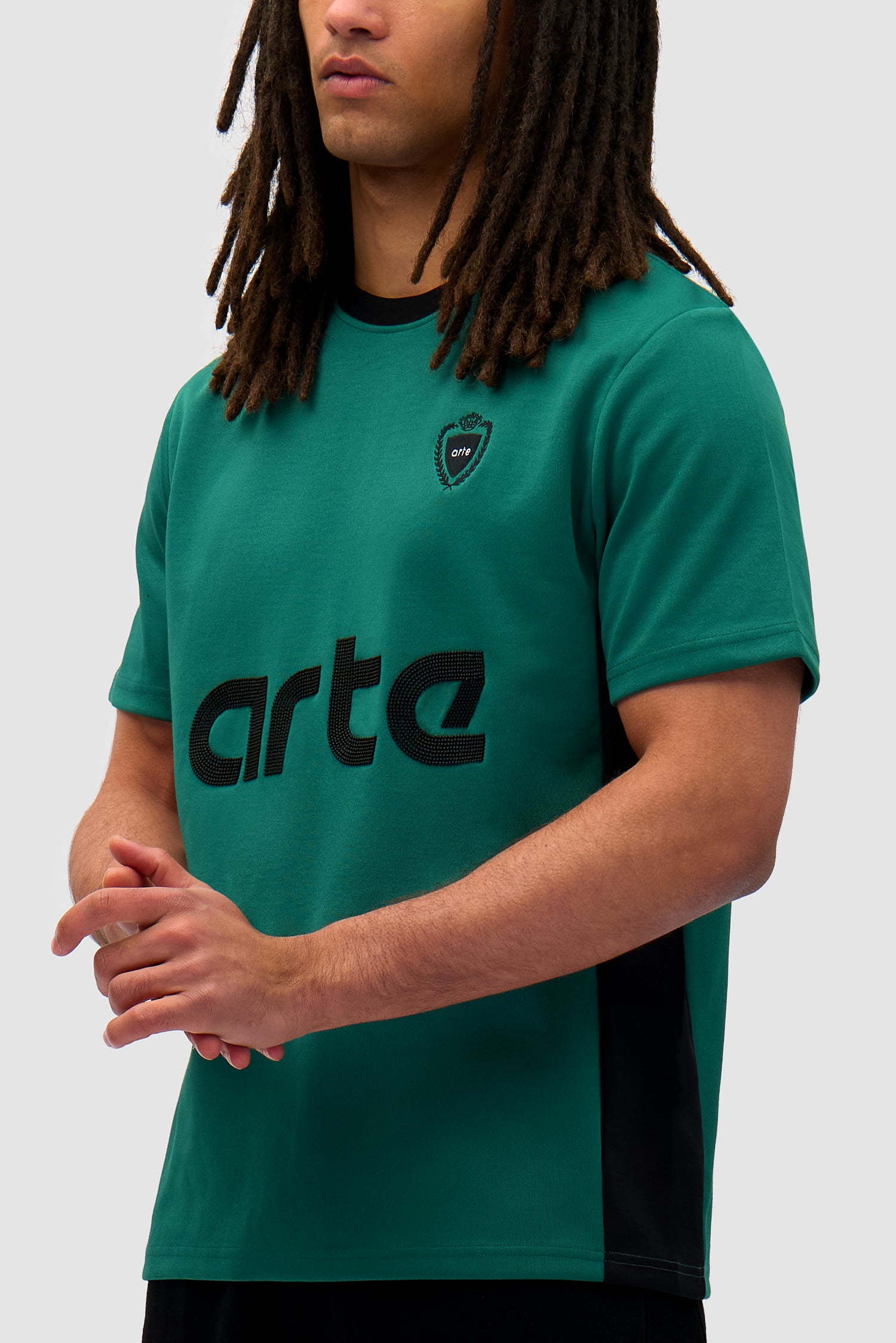 Footbal T-shirt in Green/Black worn by a model, half-body side view