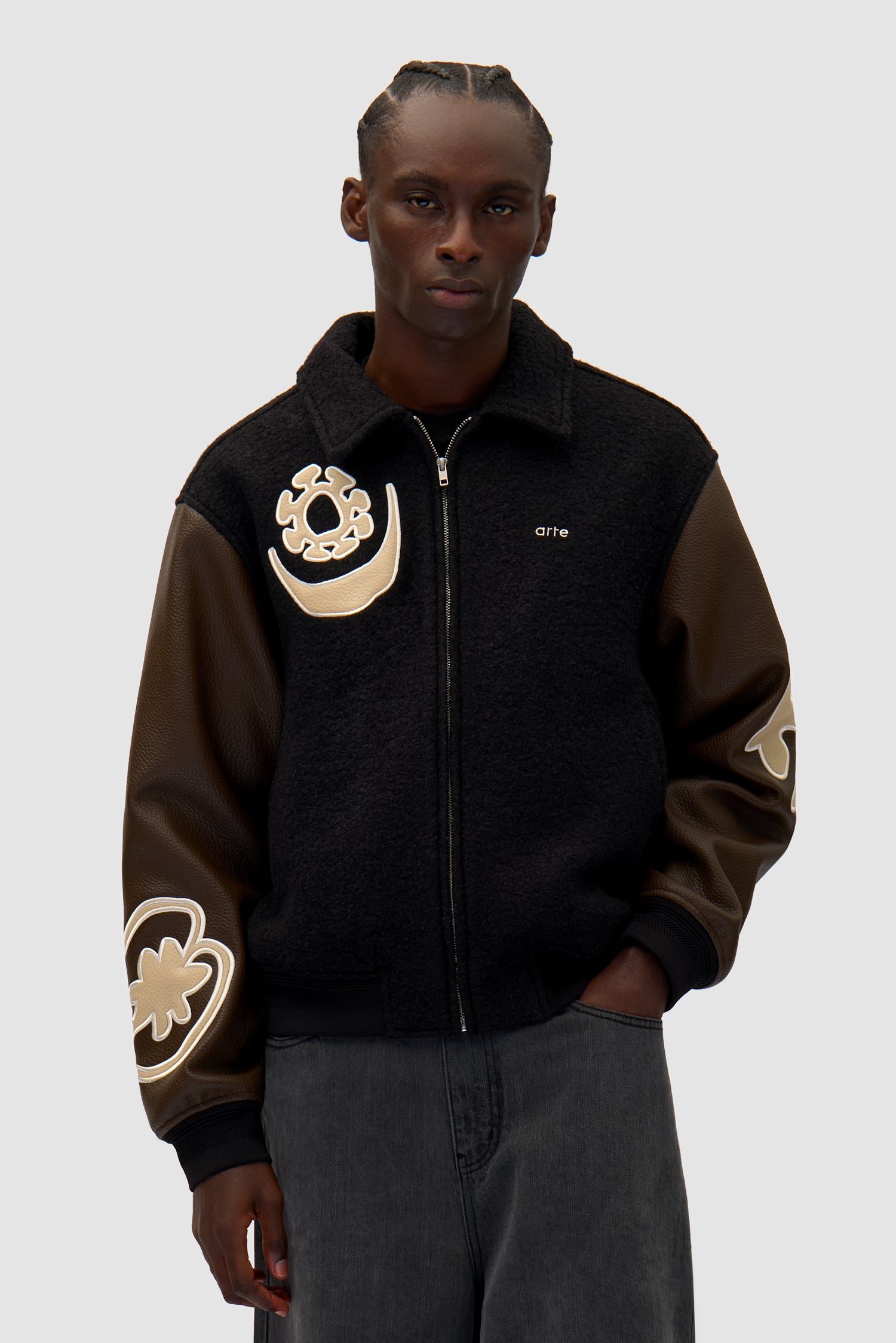 Varsity Jacket in Black/Brown worn by a model, half-body front view