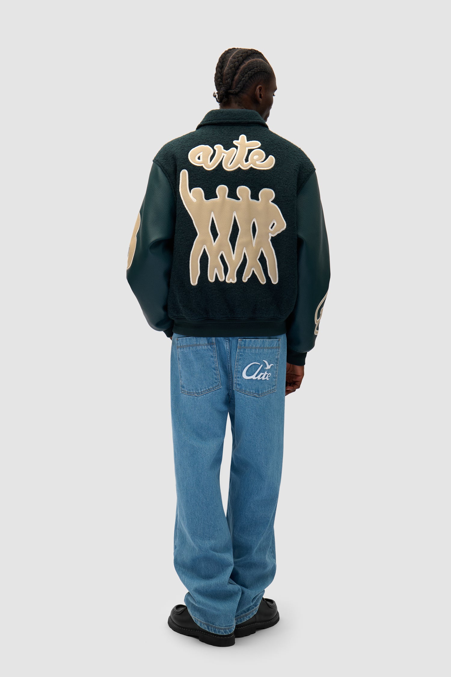 Varsity Jacket in Green worn by a model, full-body back view