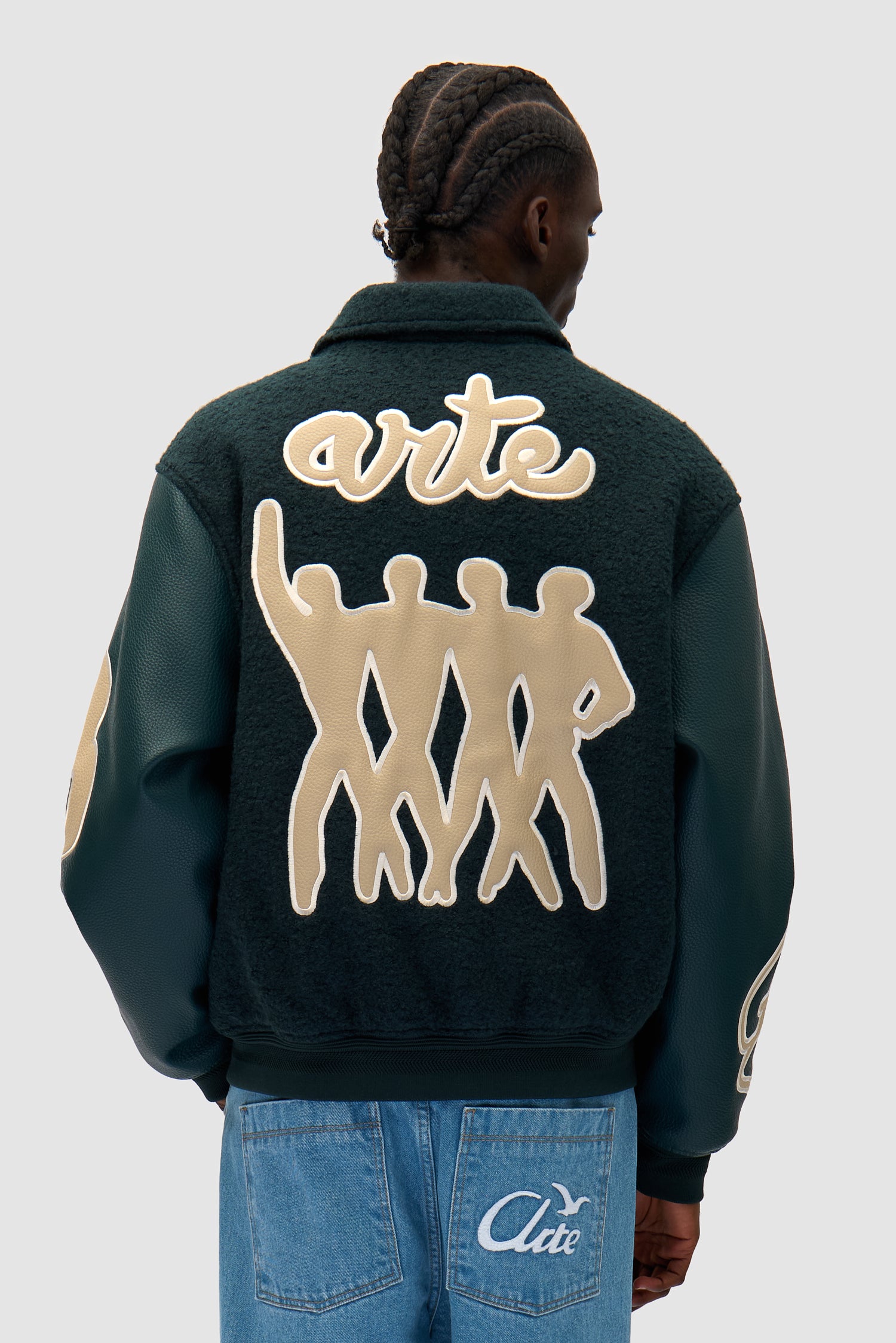 Varsity Jacket in Green worn by a model, half-body back view