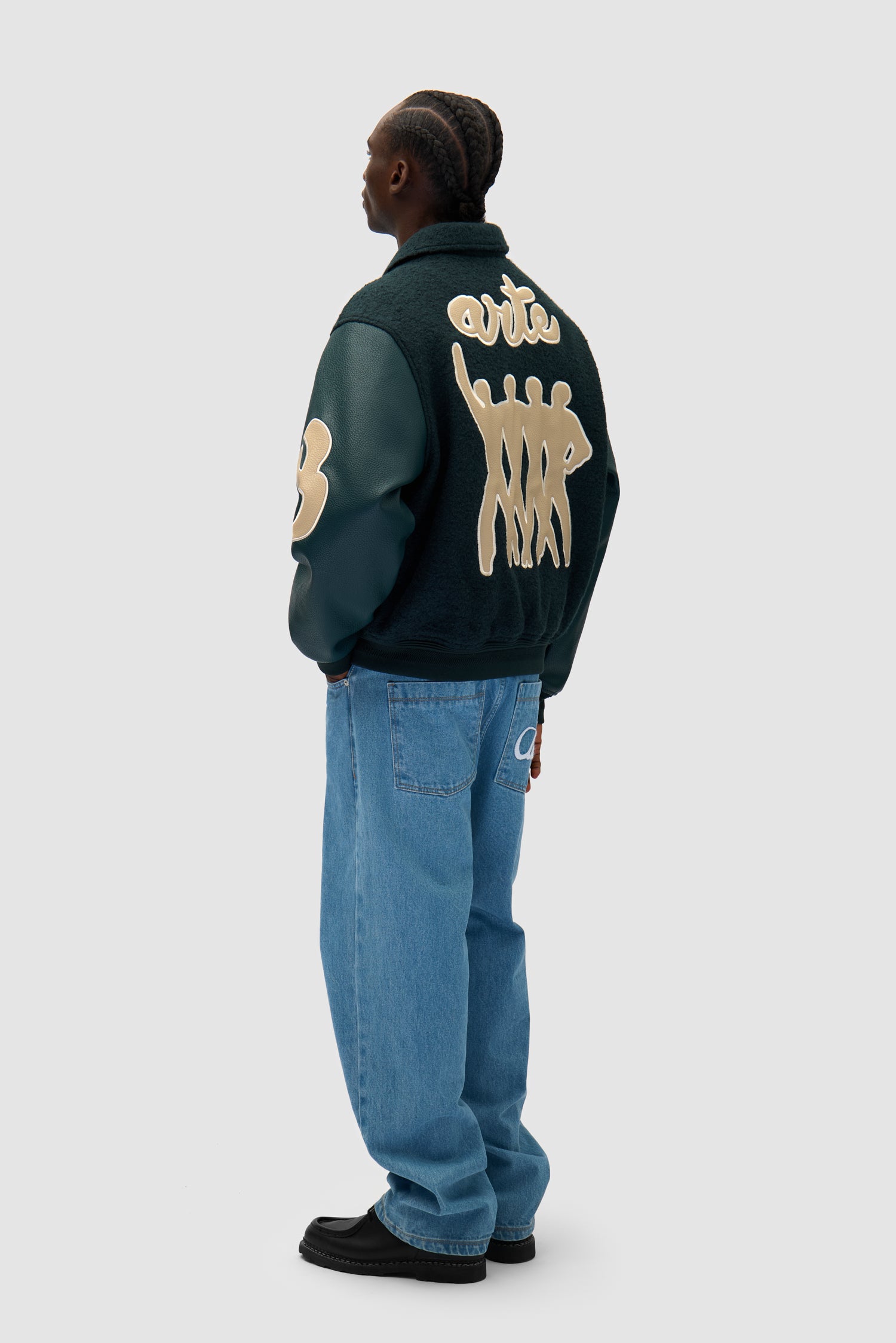 Varsity Jacket in Green worn by a model, full-body side view