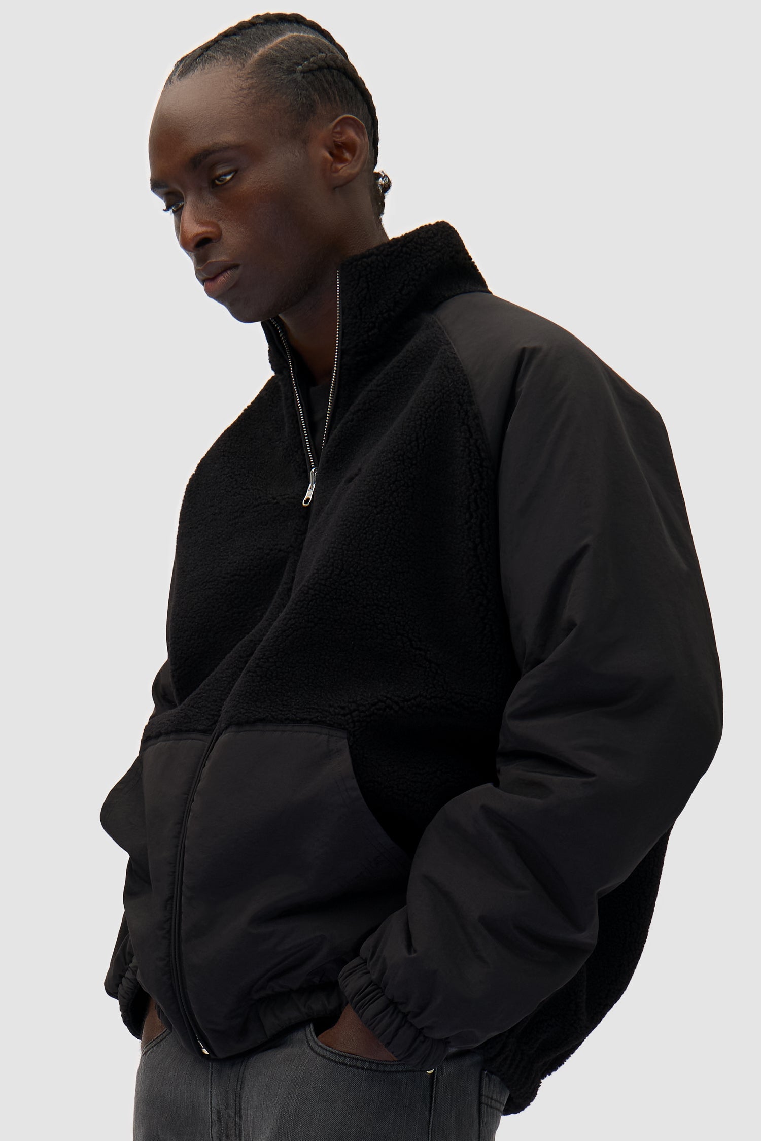 Reversible Polar Jacket in Black worn by a model, half-body back view