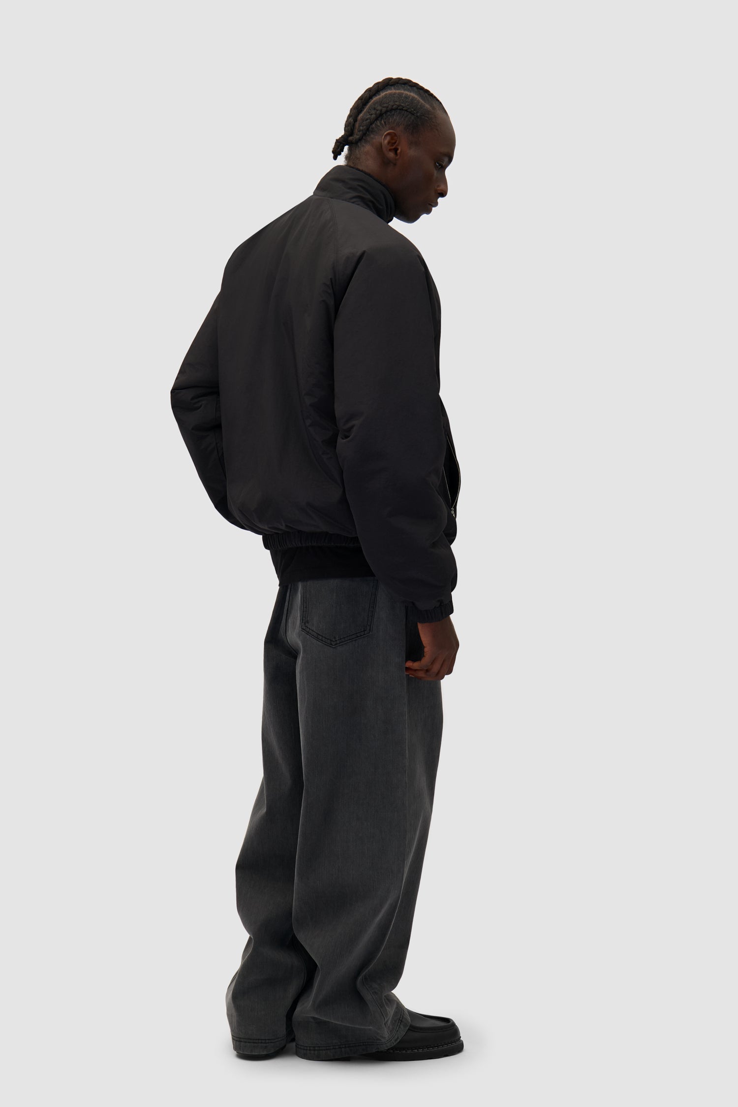 Reversible Polar Jacket in Black worn reversed by a model, full-body back view