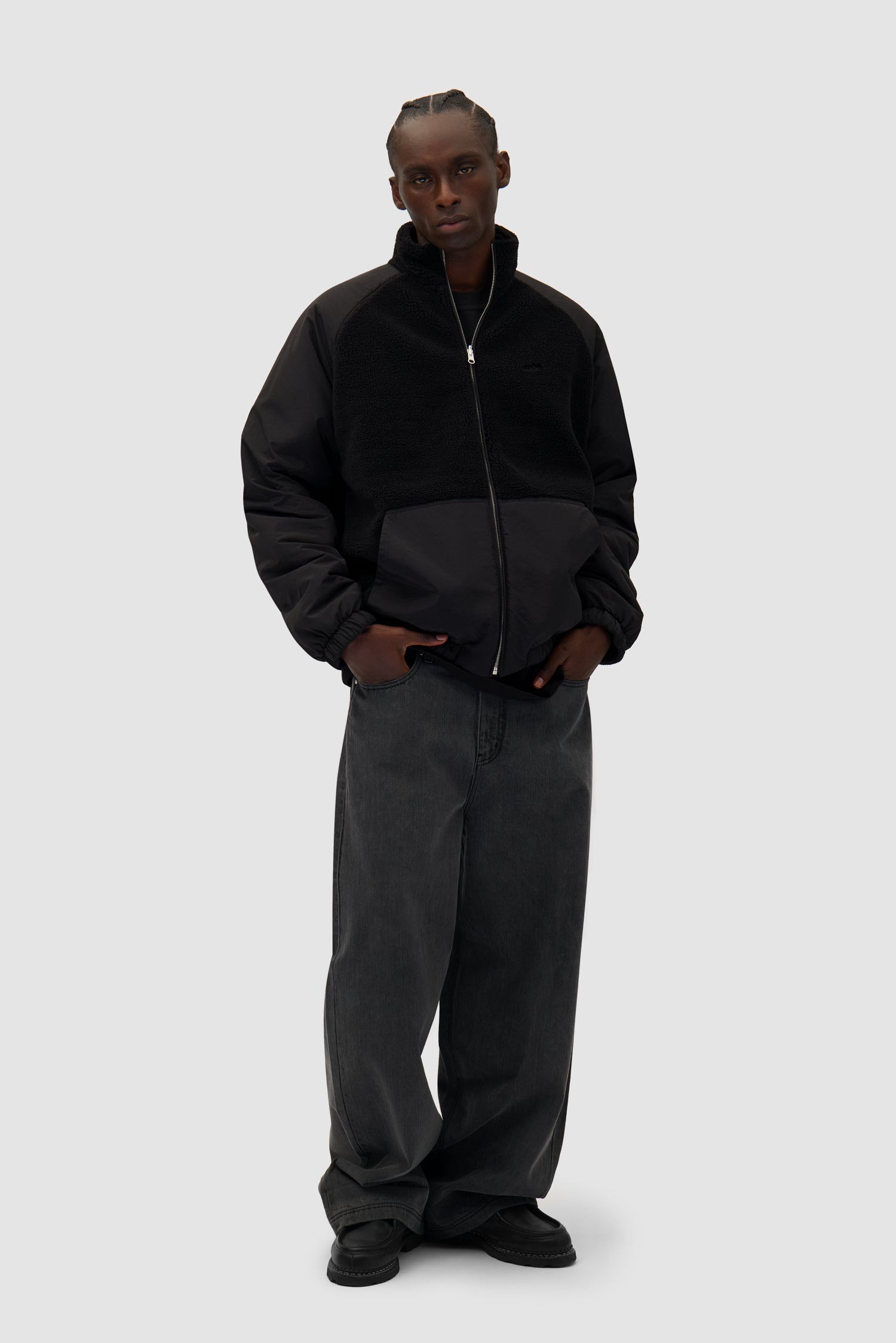 Reversible Polar Jacket in Black worn by a model, full-body side view