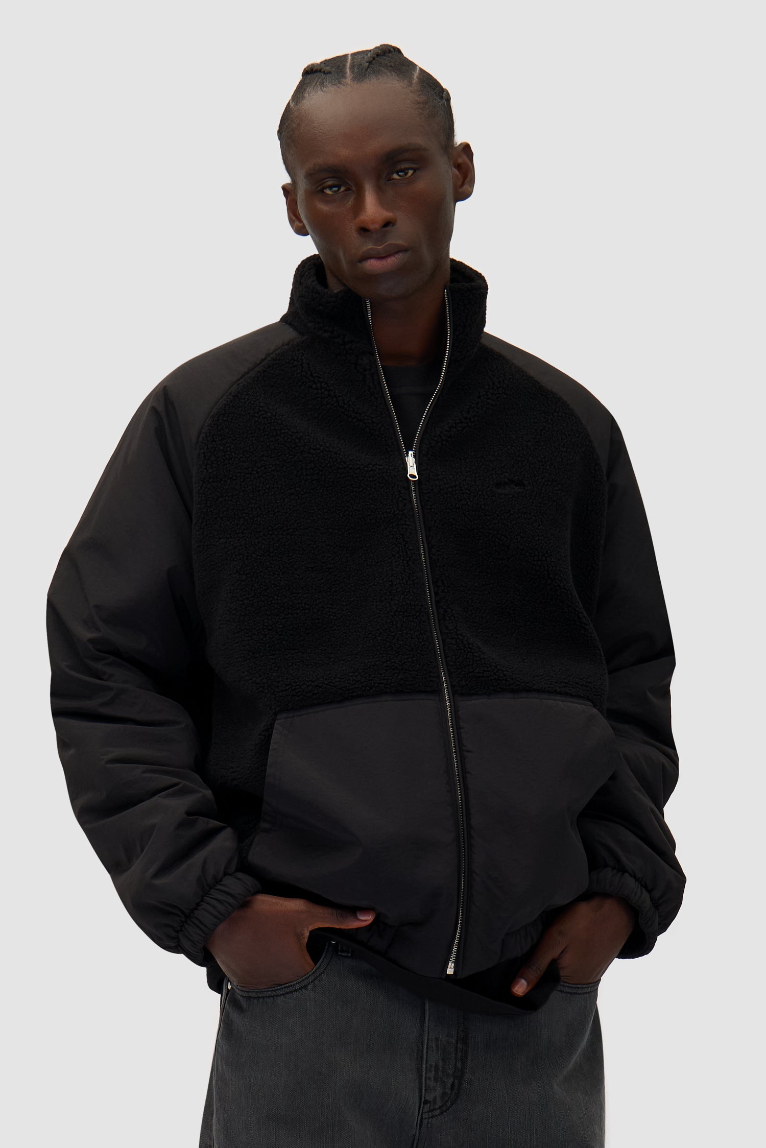 Reversible Polar Jacket in Black worn by a model, half-body front view