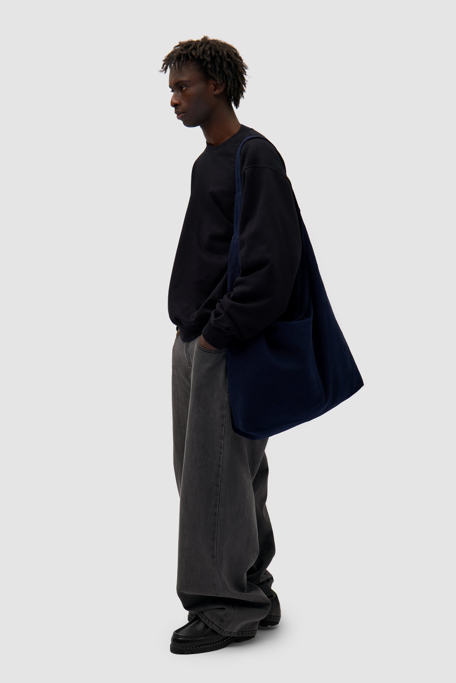 Cotton Bag in Navy worn by a model, full-body front view