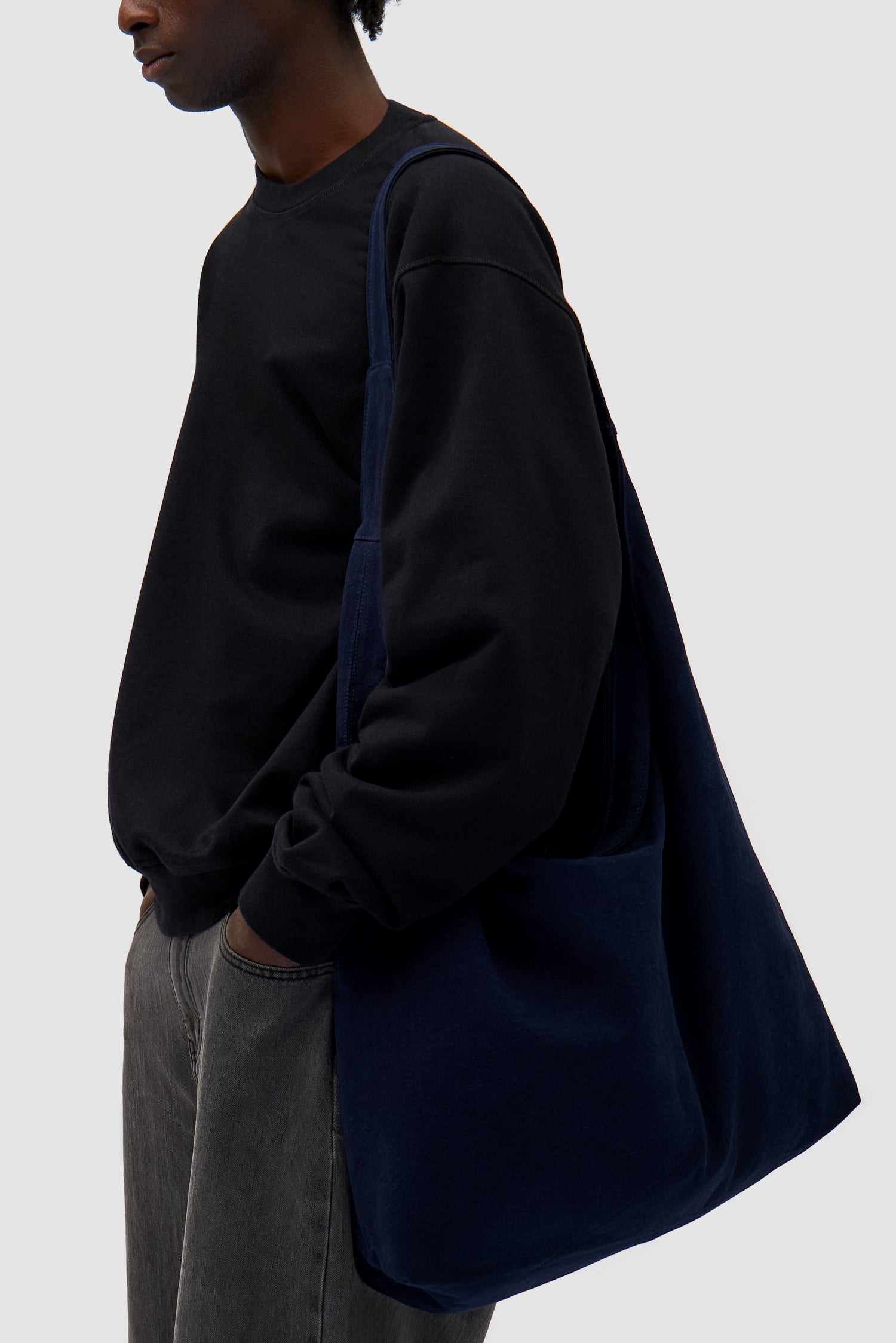Cotton Bag in Navy worn by a model, half-body front view