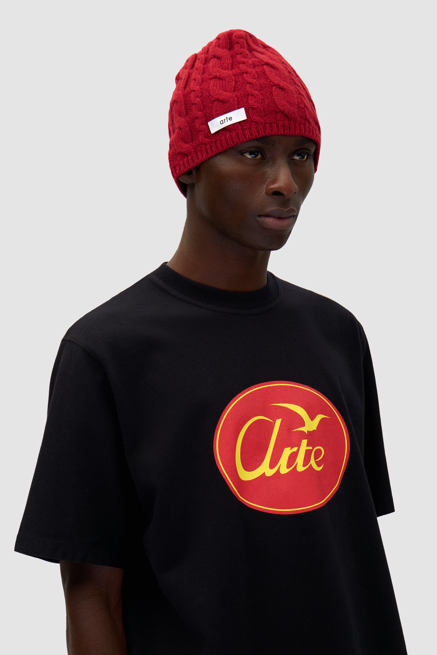 Braided Beanie in Red worn by a model, half-body front view