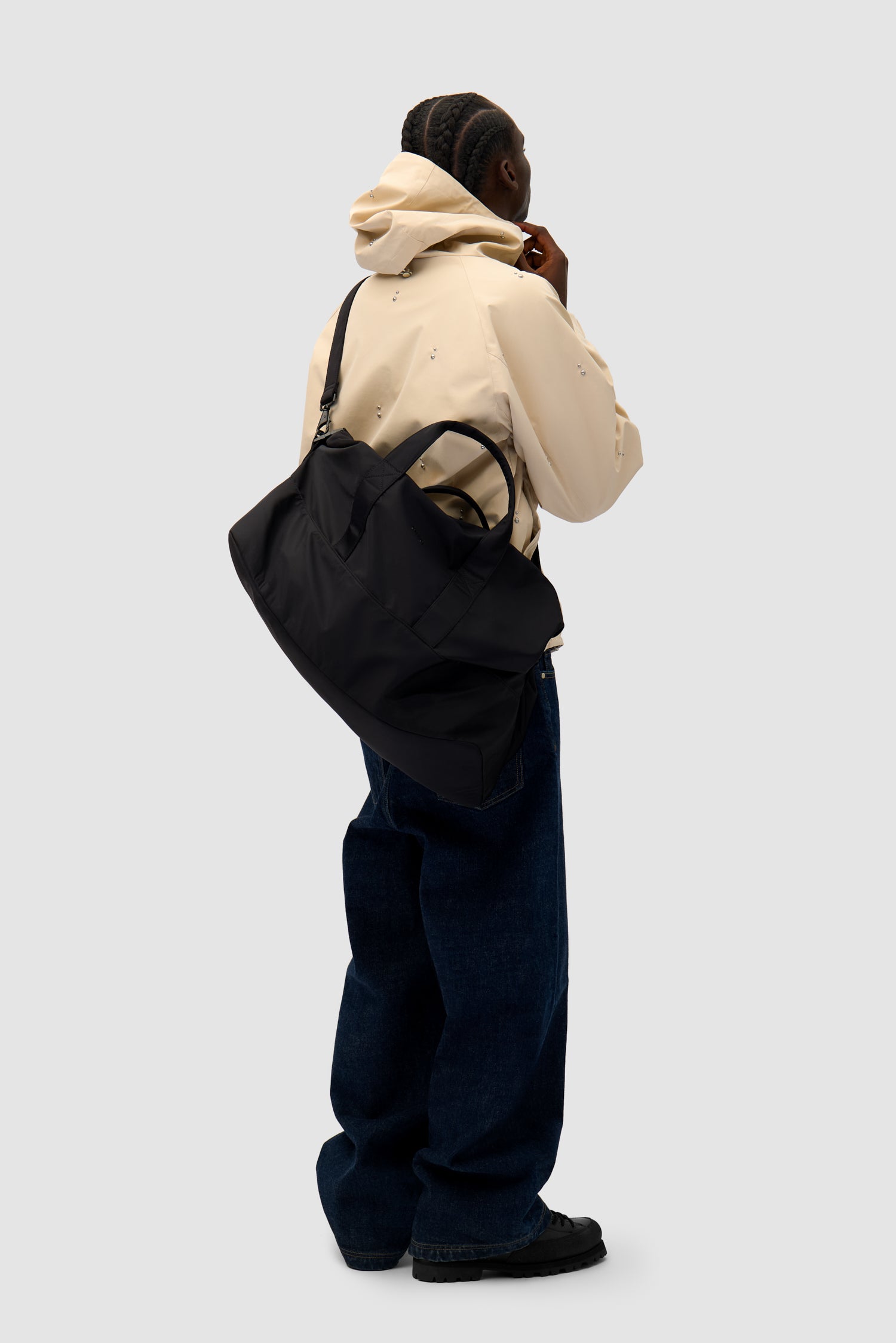 Nylon Duffle Bag in Black worn by a model, half-body front view