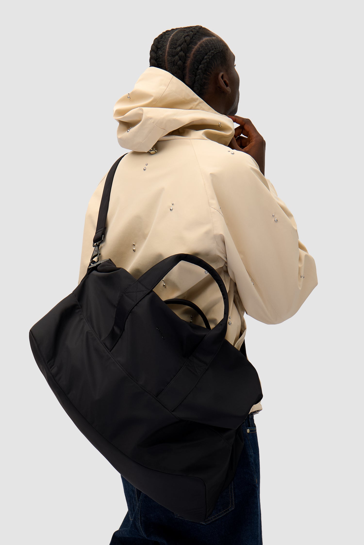 Nylon Duffle Bag in Black worn by a model, full-body front view