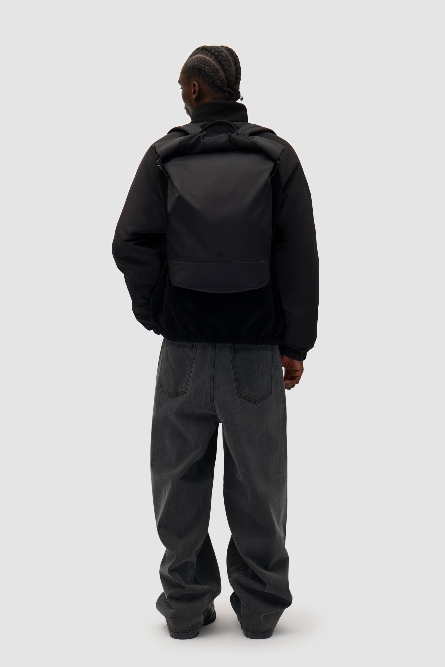 Roll-up Backpack Nylon in Black worn by a model, half-body front view