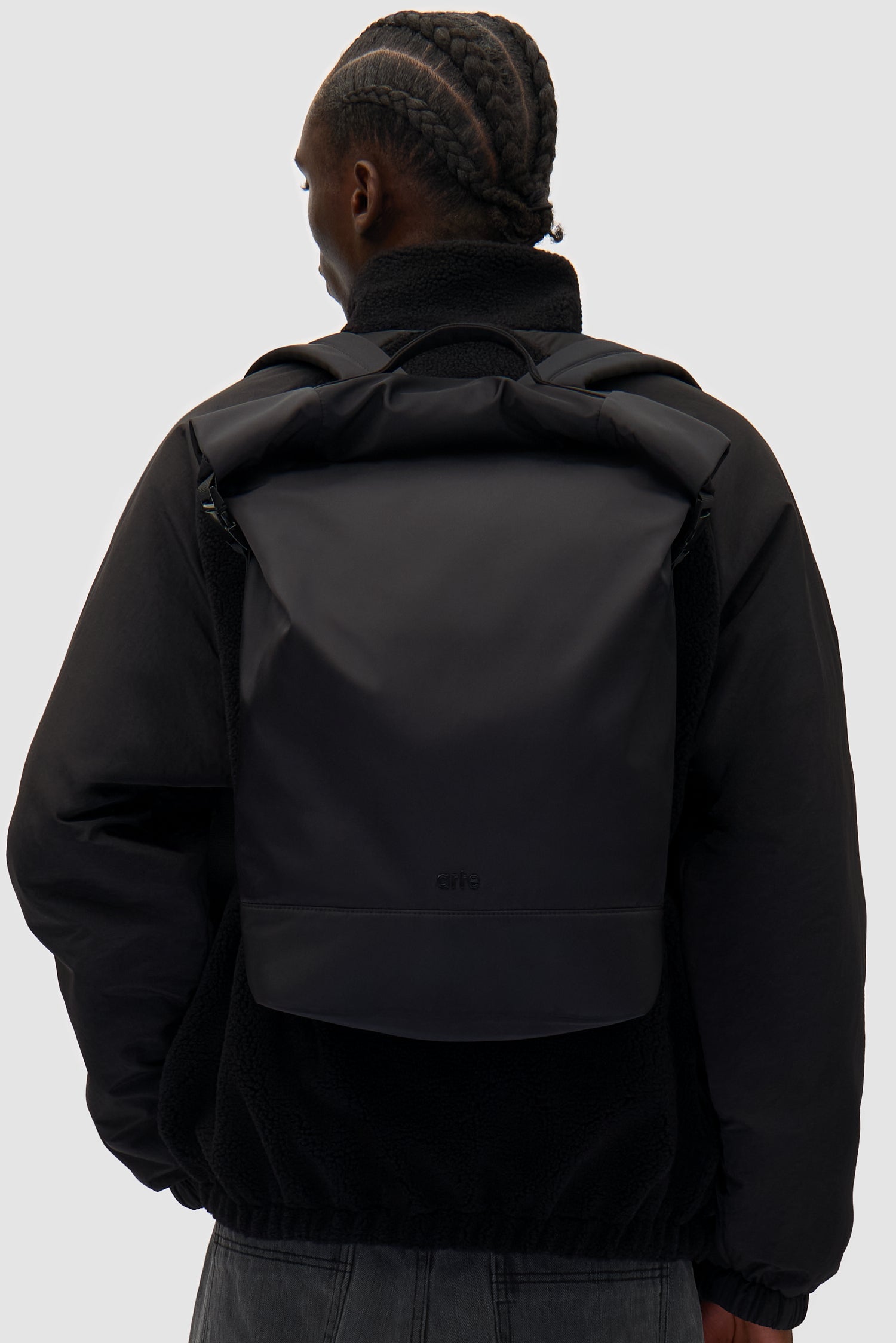 Roll-up Backpack Nylon in Black worn by a model, full-body front view