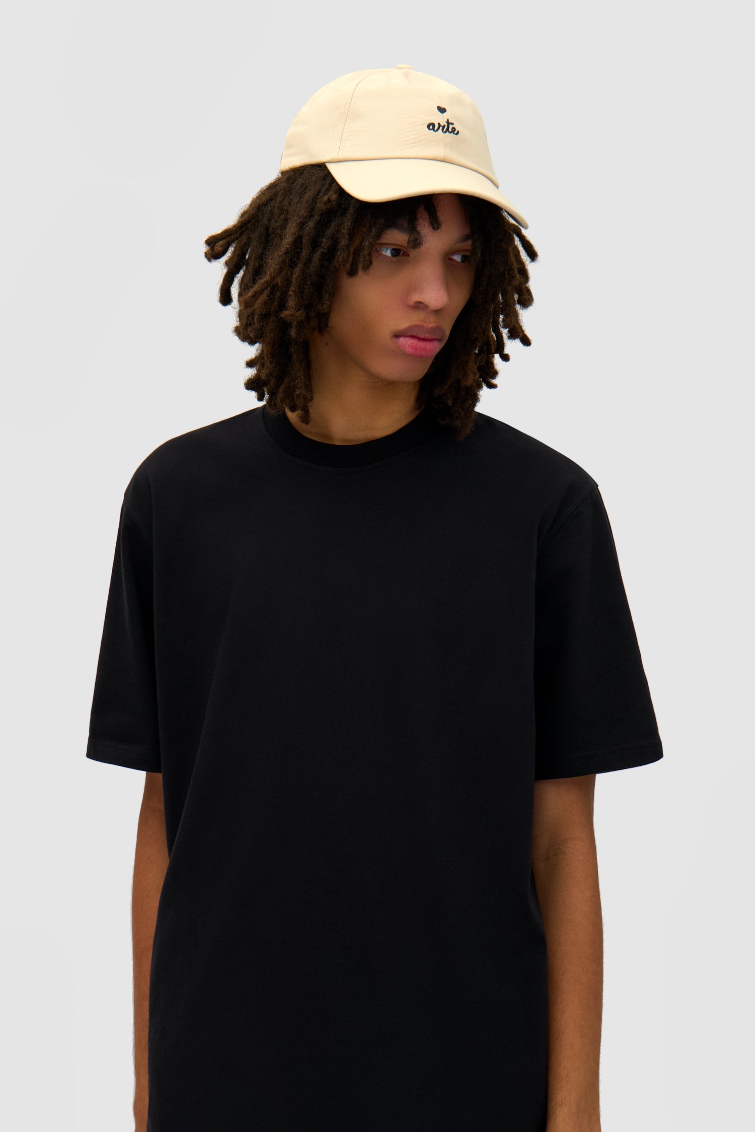 Heart Logo Cap in Cream worn by a model, half-body front view