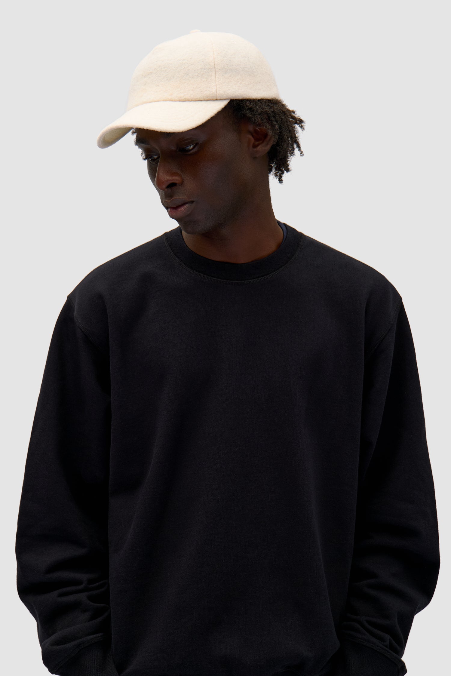 Wool Cap in Cream worn by a model, half-body front view