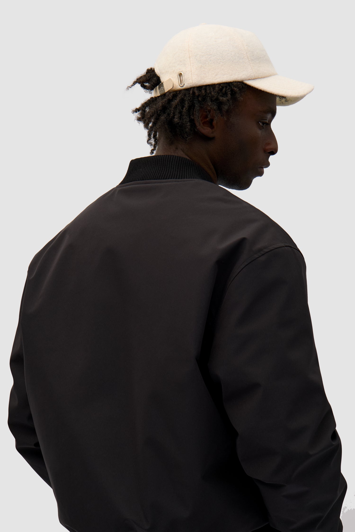 Wool Cap in Cream worn by a model, full-body front view