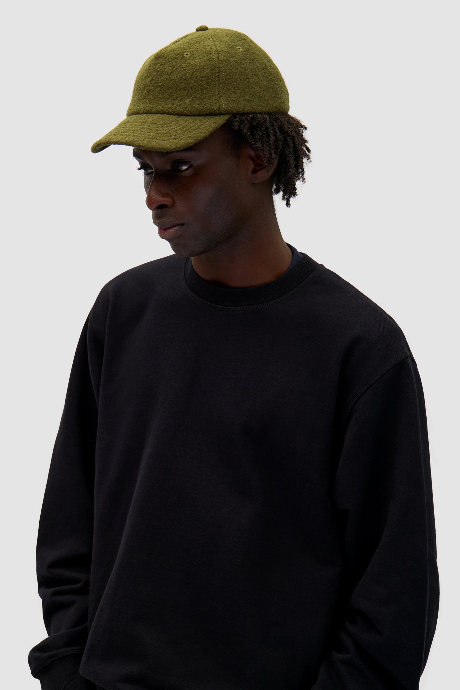 Wool Cap in Green worn by a model, half-body front view