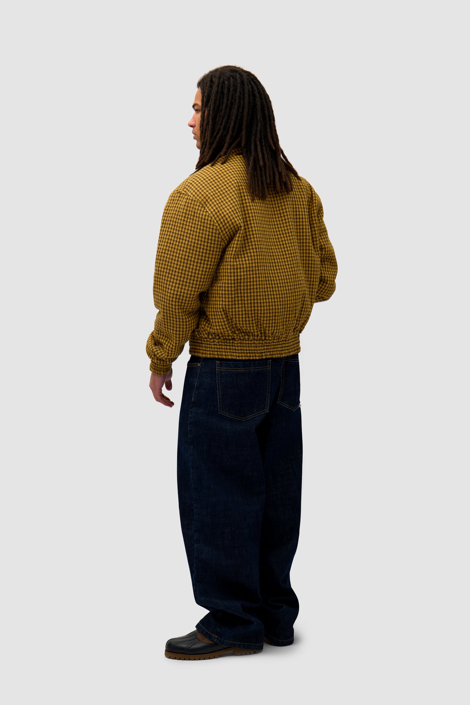Reversible Nylon Jacket in Brown/Yellow worn reversed by a model, full-body back view