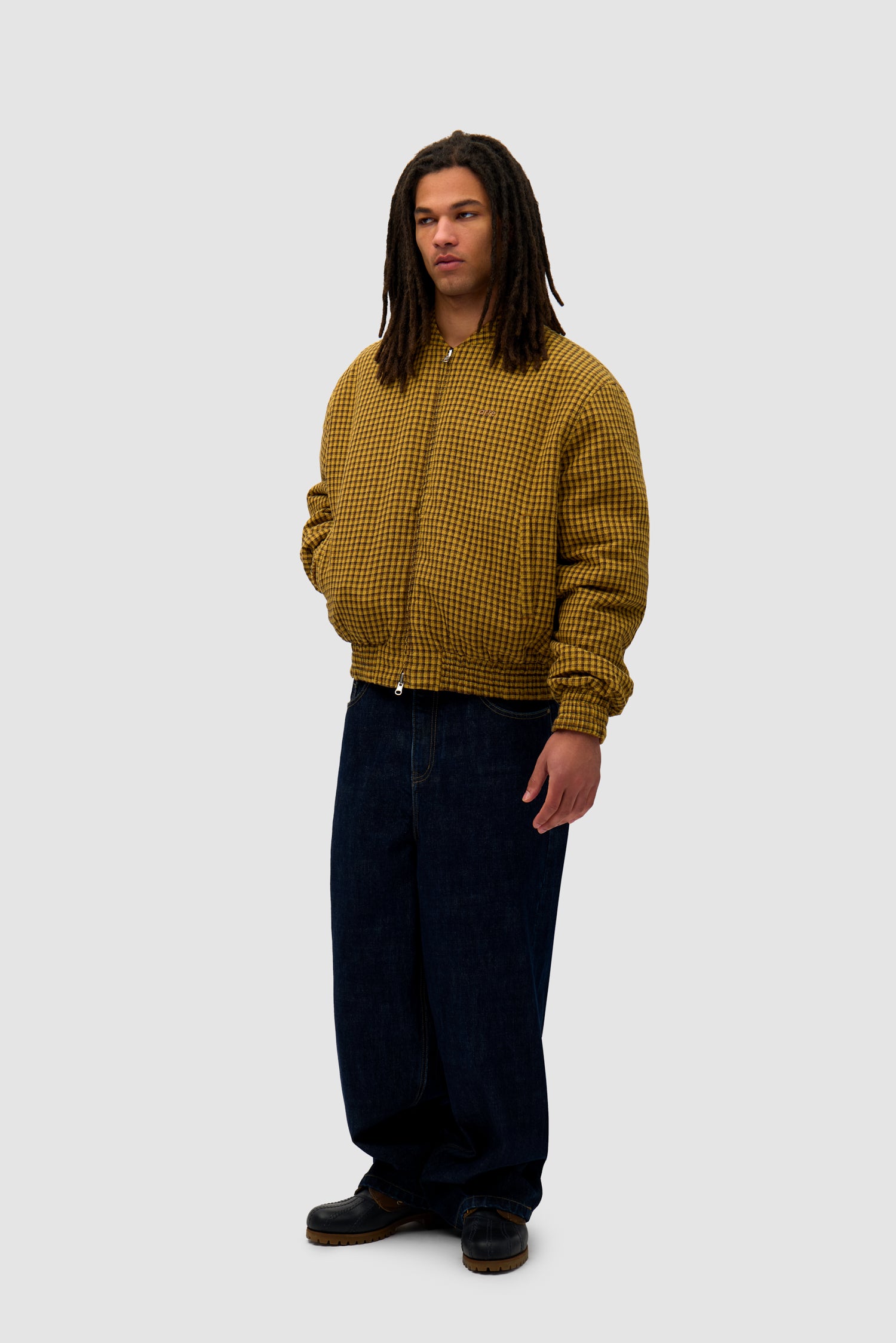 Reversible Nylon Jacket in Brown/Yellow worn reversed by a model, full-body side view