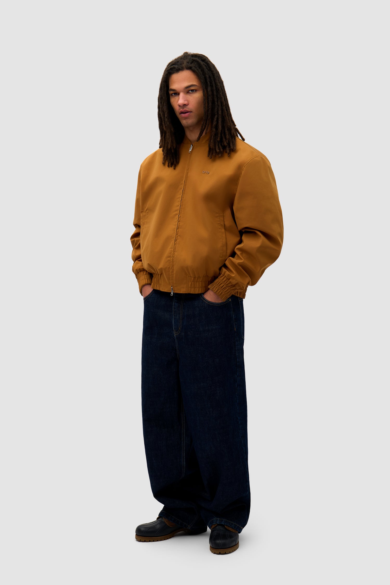 Reversible Nylon Jacket in Brown/Yellow worn by a model, full-body side view