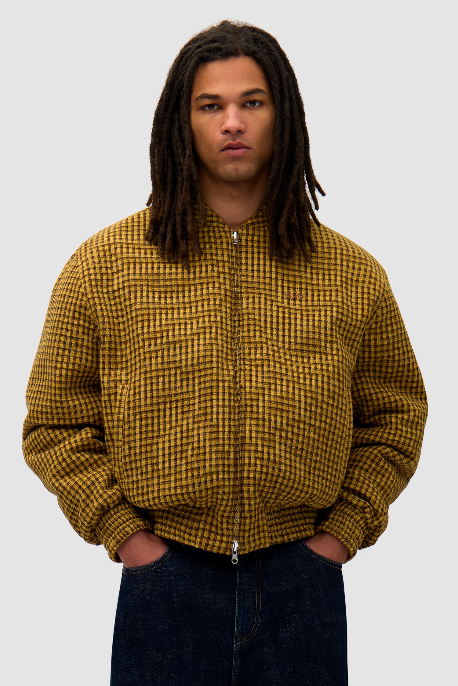 Reversible Nylon Jacket in Brown/Yellow worn reversed by a model, half-body front view