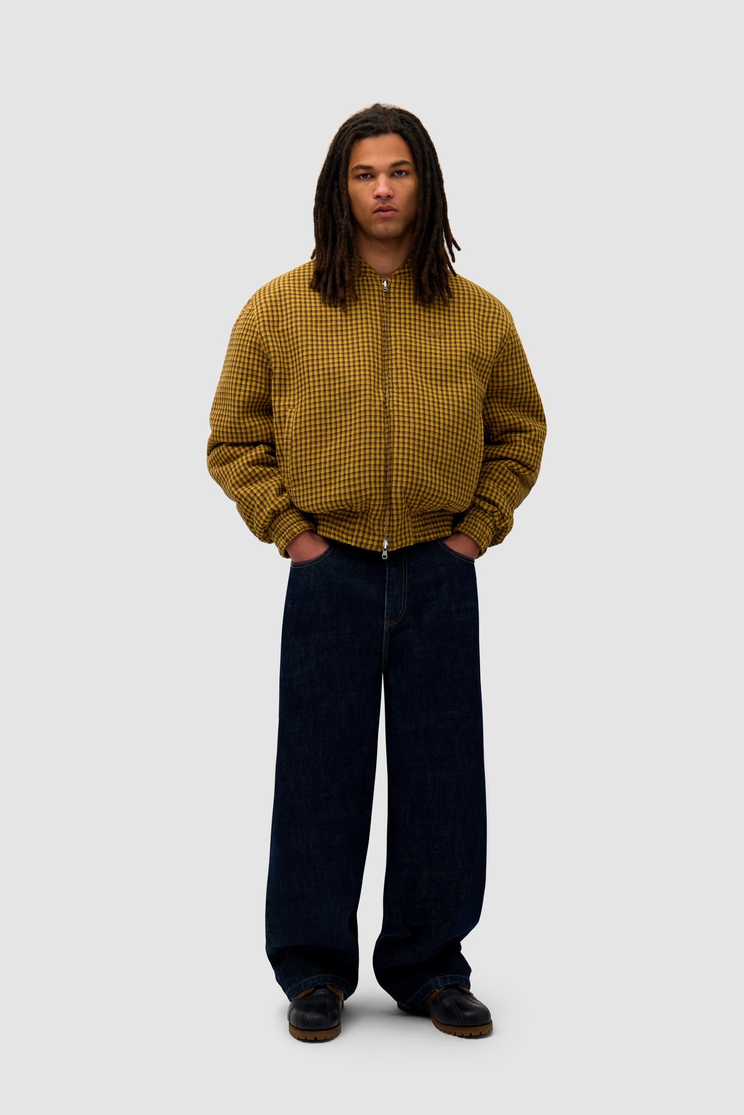 Reversible Nylon Jacket in Brown/Yellow worn reversed by a model, full-body front view