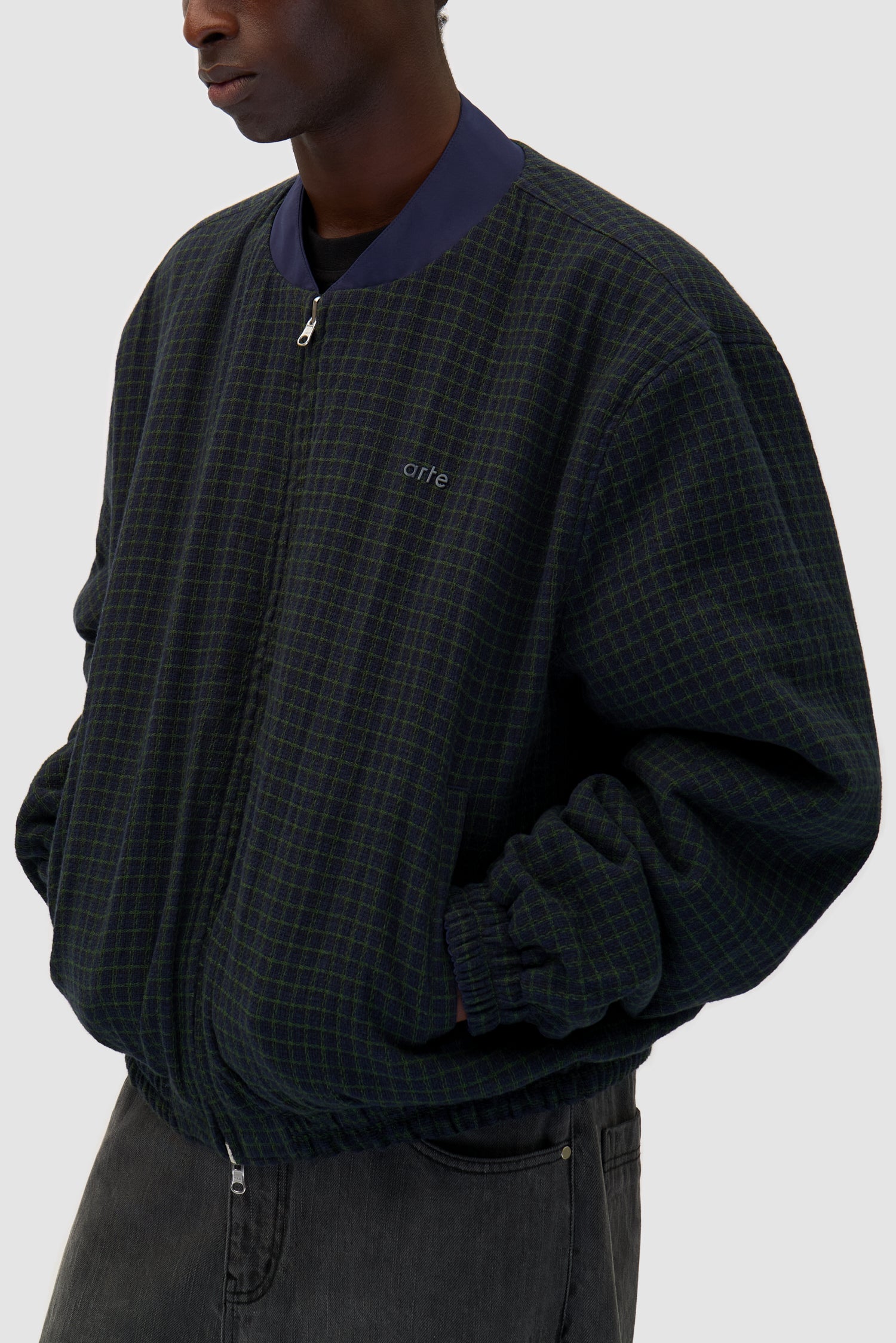 Reversible Nylon Jacket in Navy/Green worn reversed by a model, half-body front view logo detail