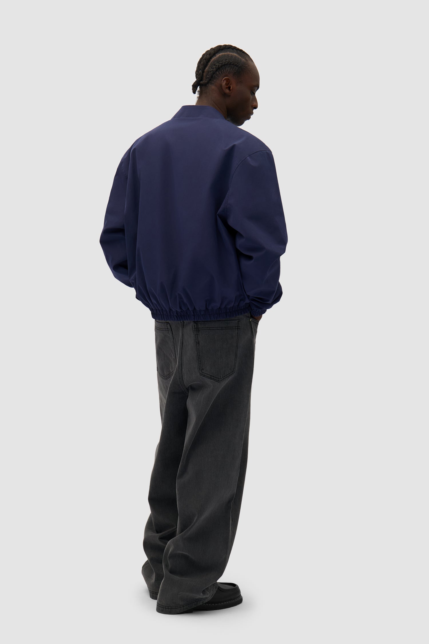 Reversible Nylon Jacket in Navy/Green worn by a model, full-body back view