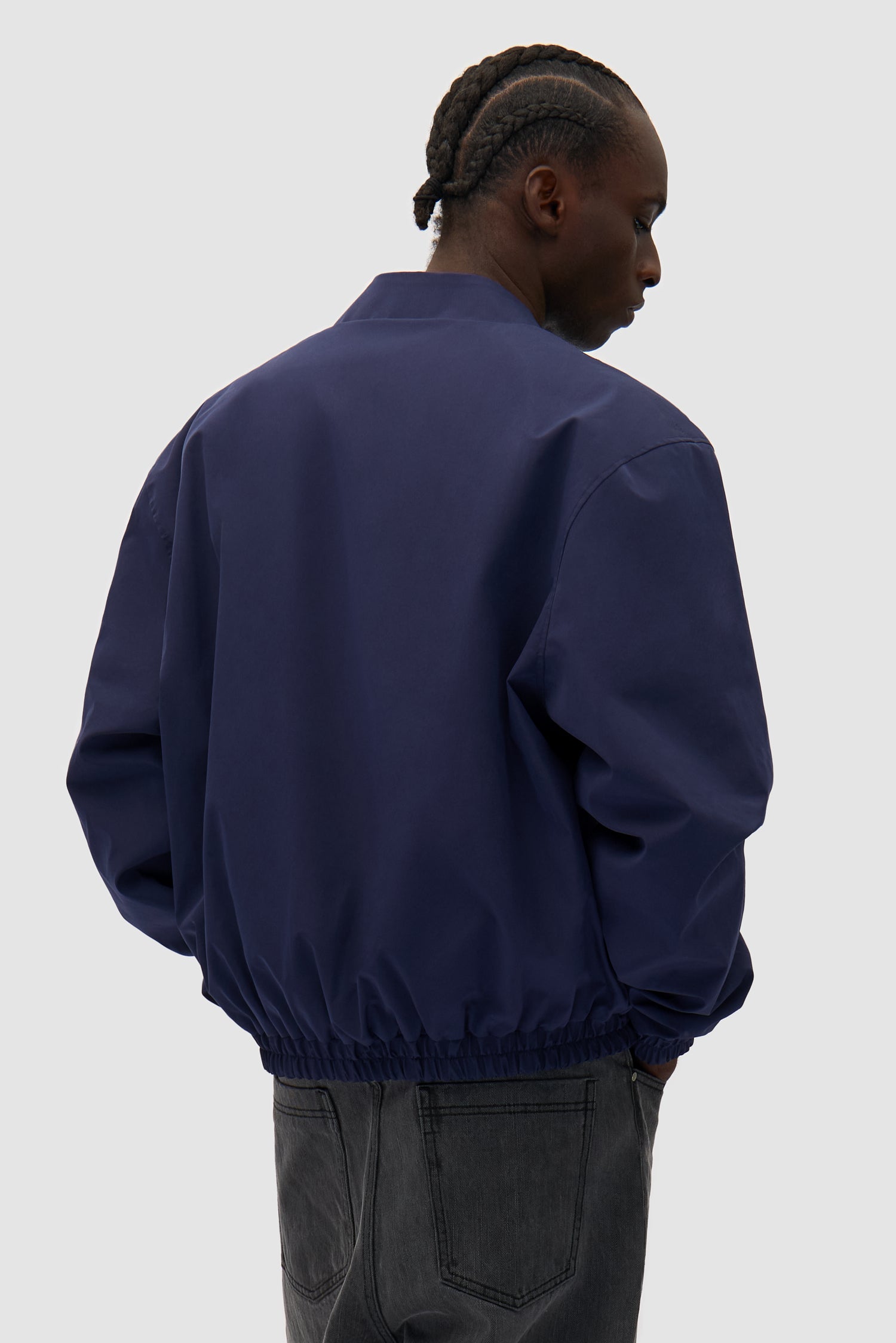 Reversible Nylon Jacket in Navy/Green worn by a model, half-body back view
