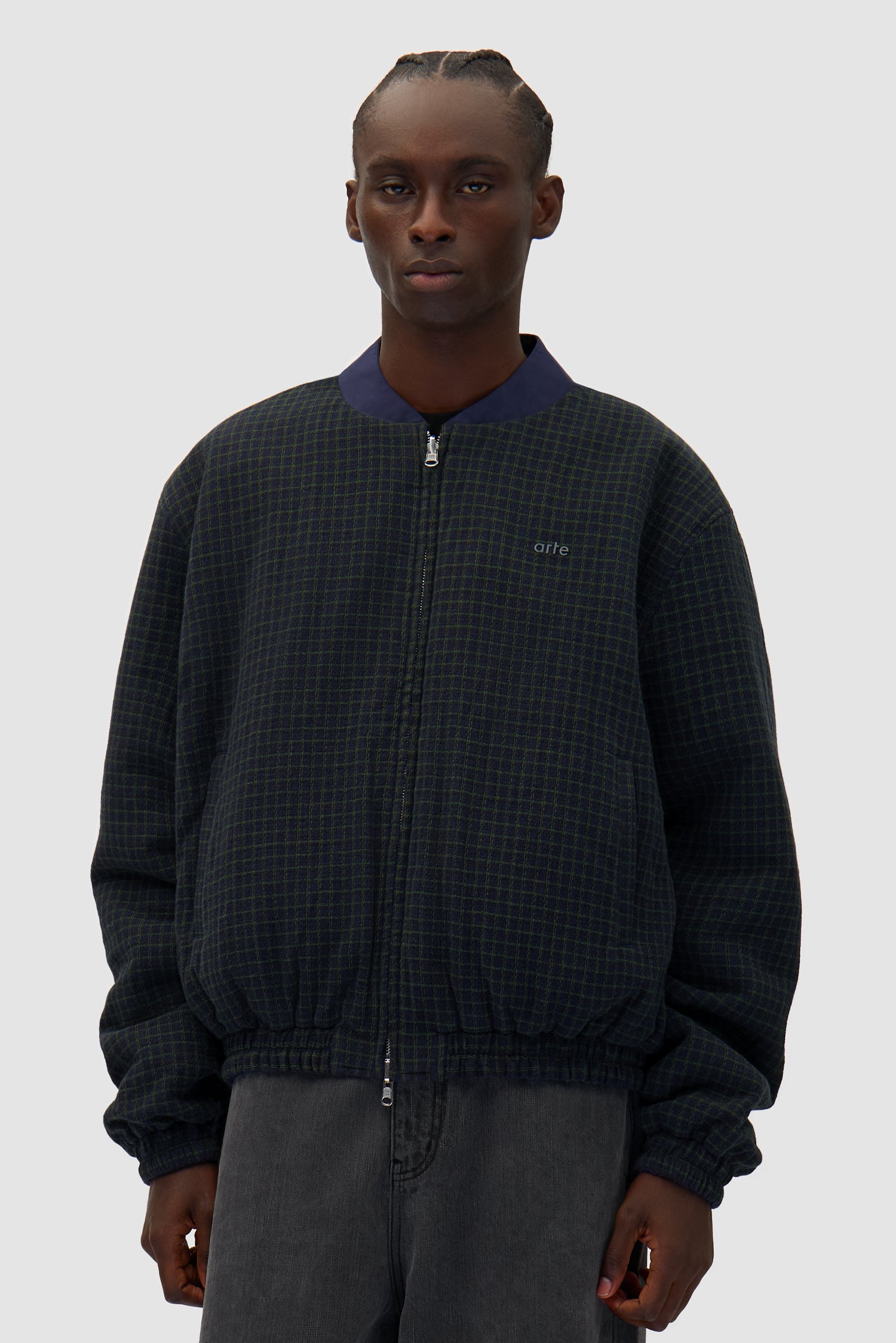 Reversible Nylon Jacket in Navy/Green worn reversed by a model, half-body front view