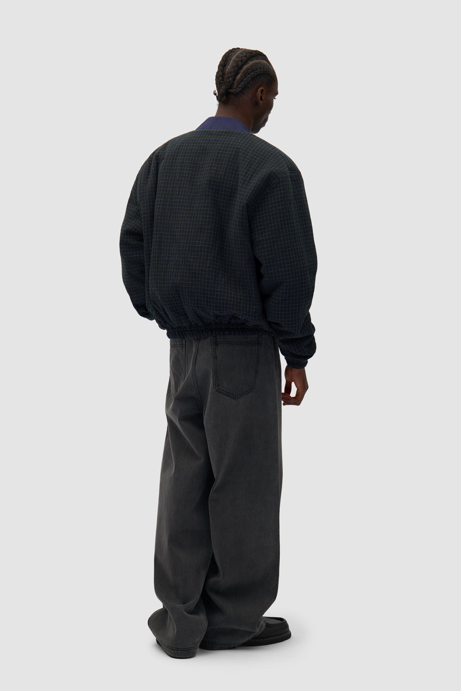 Reversible Nylon Jacket in Navy/Green worn reversed by a model, full-body back view