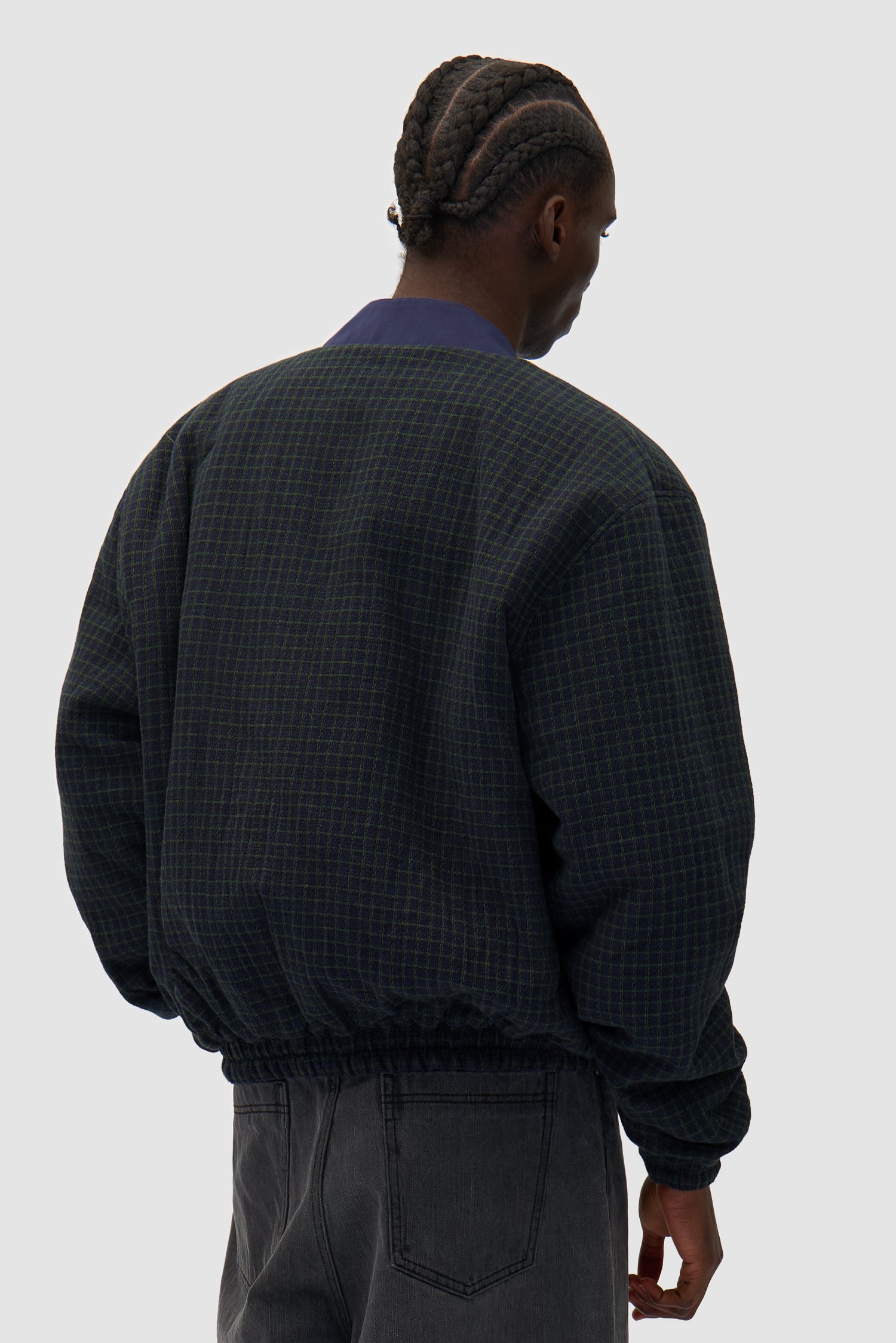 Reversible Nylon Jacket in Navy/Green worn reversed by a model, half-body back view