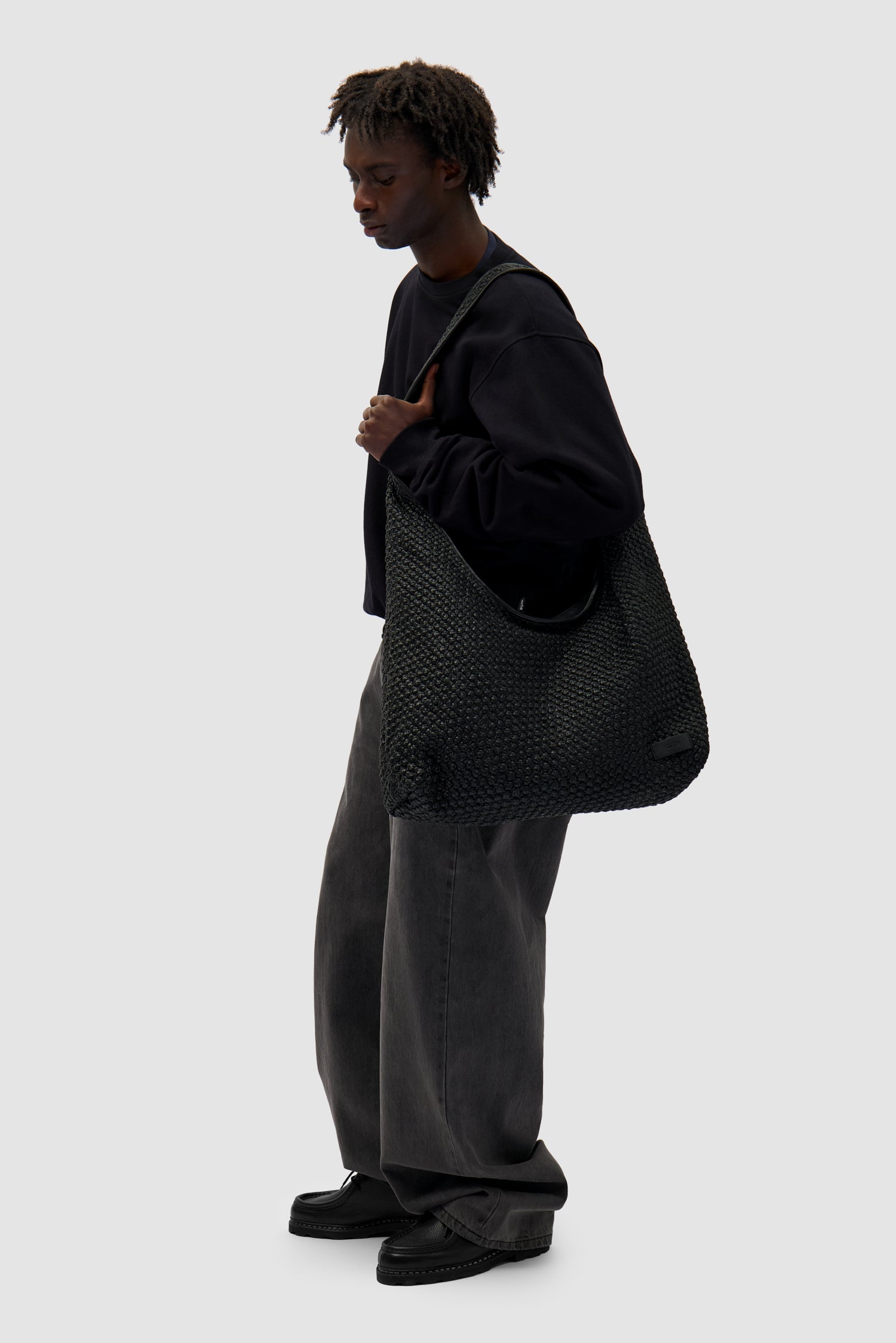 Big Braided Leather Bag in Black worn by a model, full-body front view