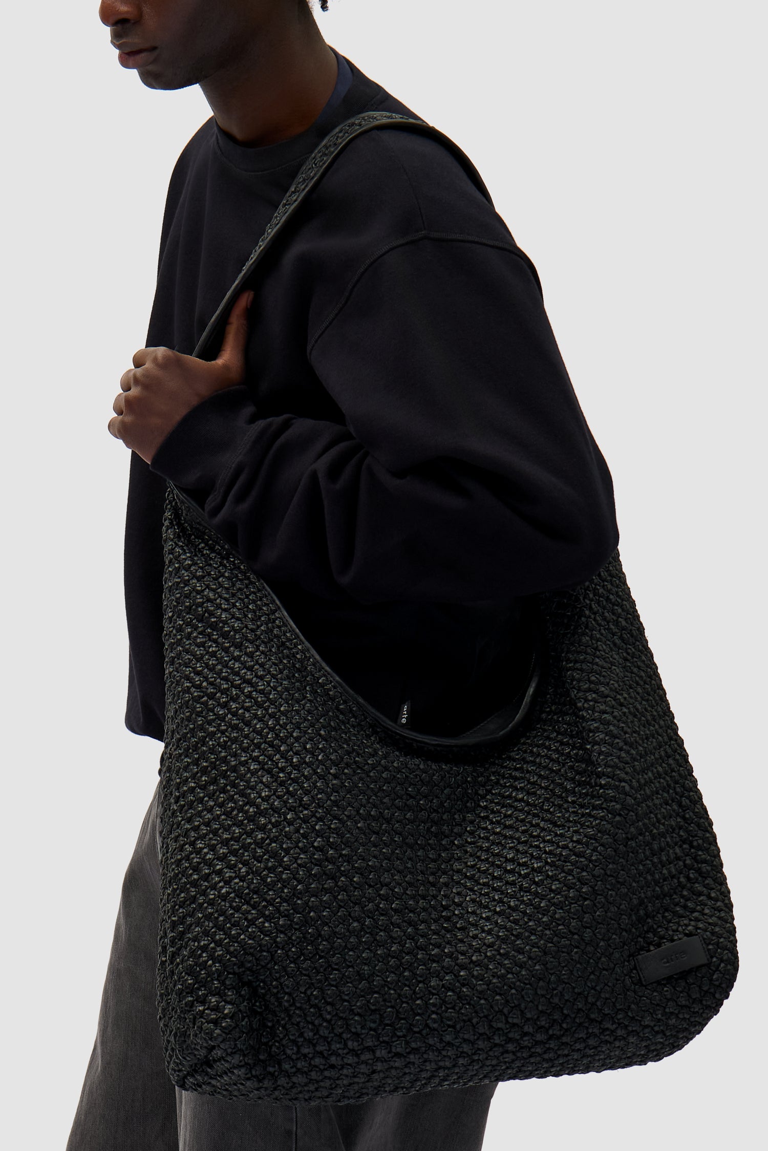 Big Braided Leather Bag in Black worn by a model, half-body front view