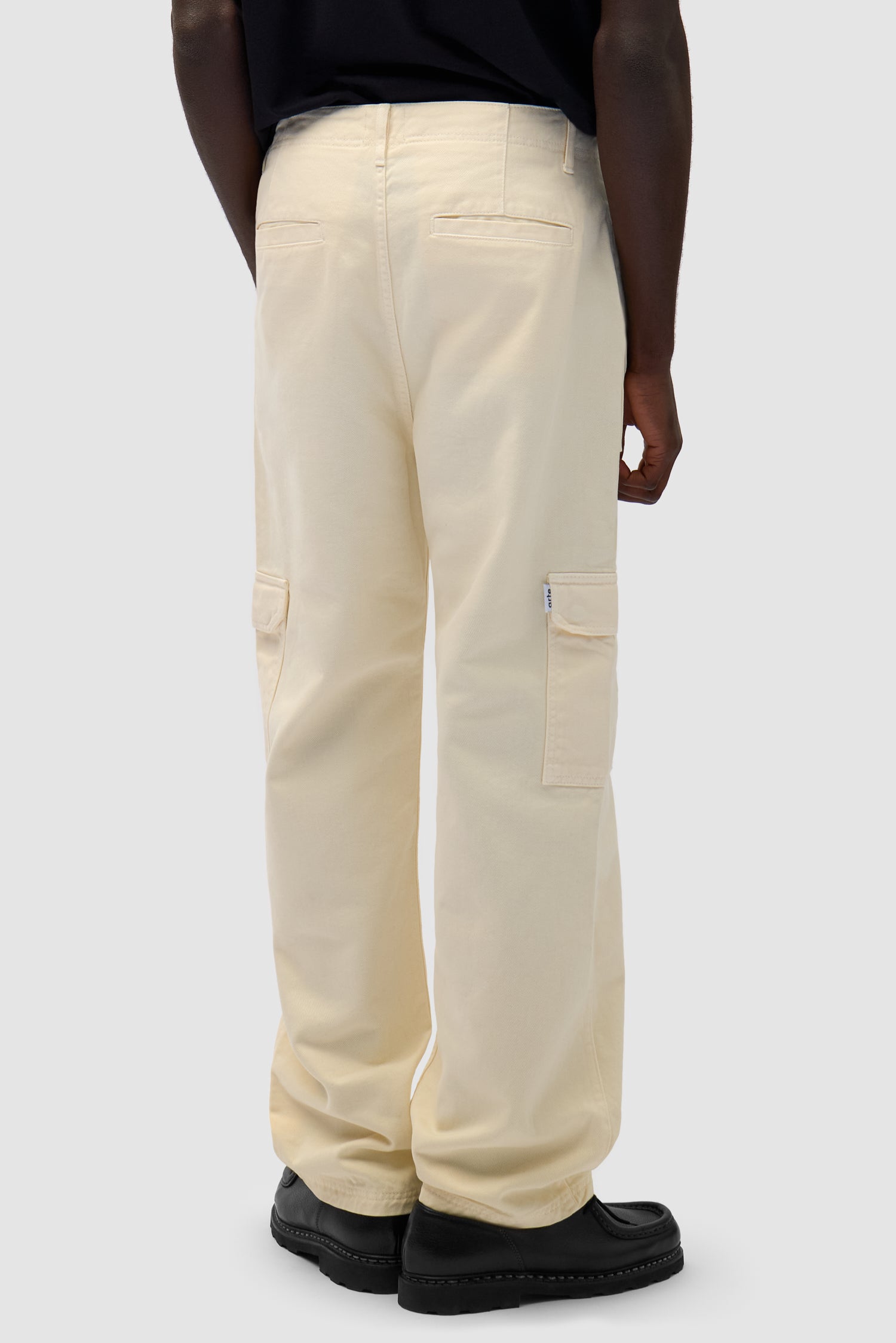 Cargo Pants in Cream worn by a model, half-body back view