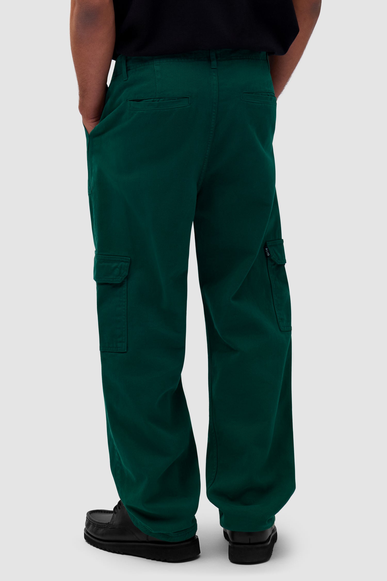 Cargo Pants in Green worn by a model, half-body back view