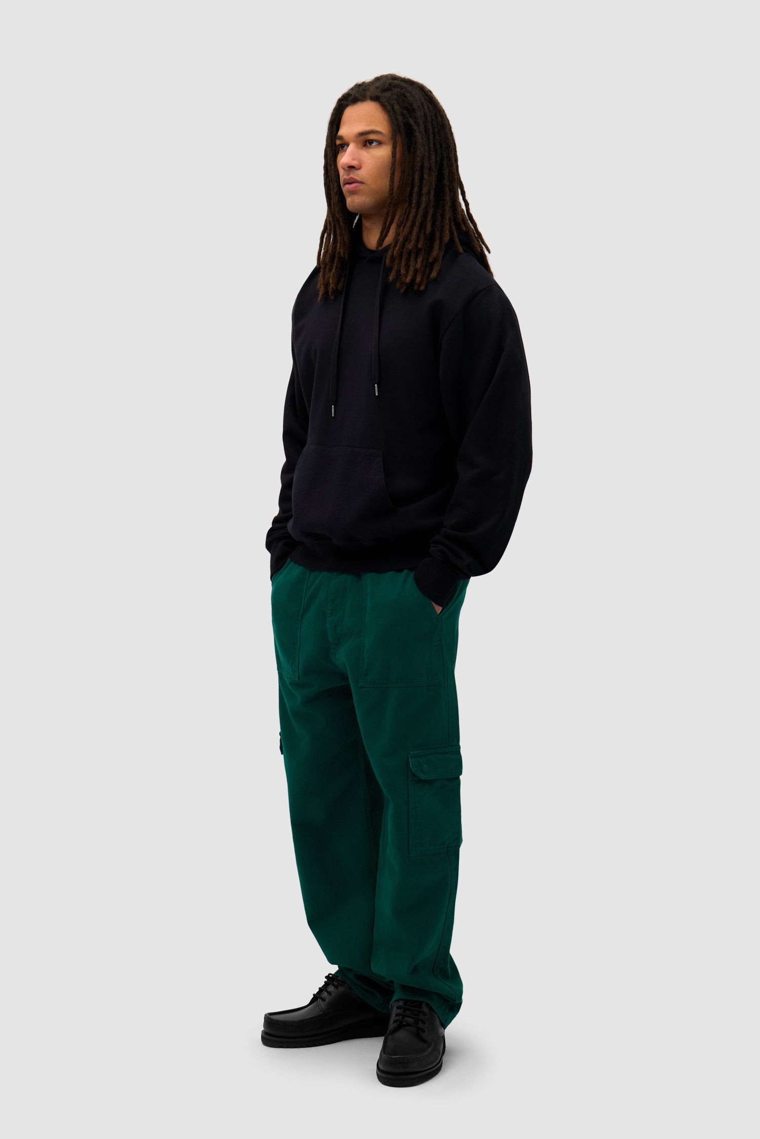 Cargo Pants in Green worn by a model, full-body side view
